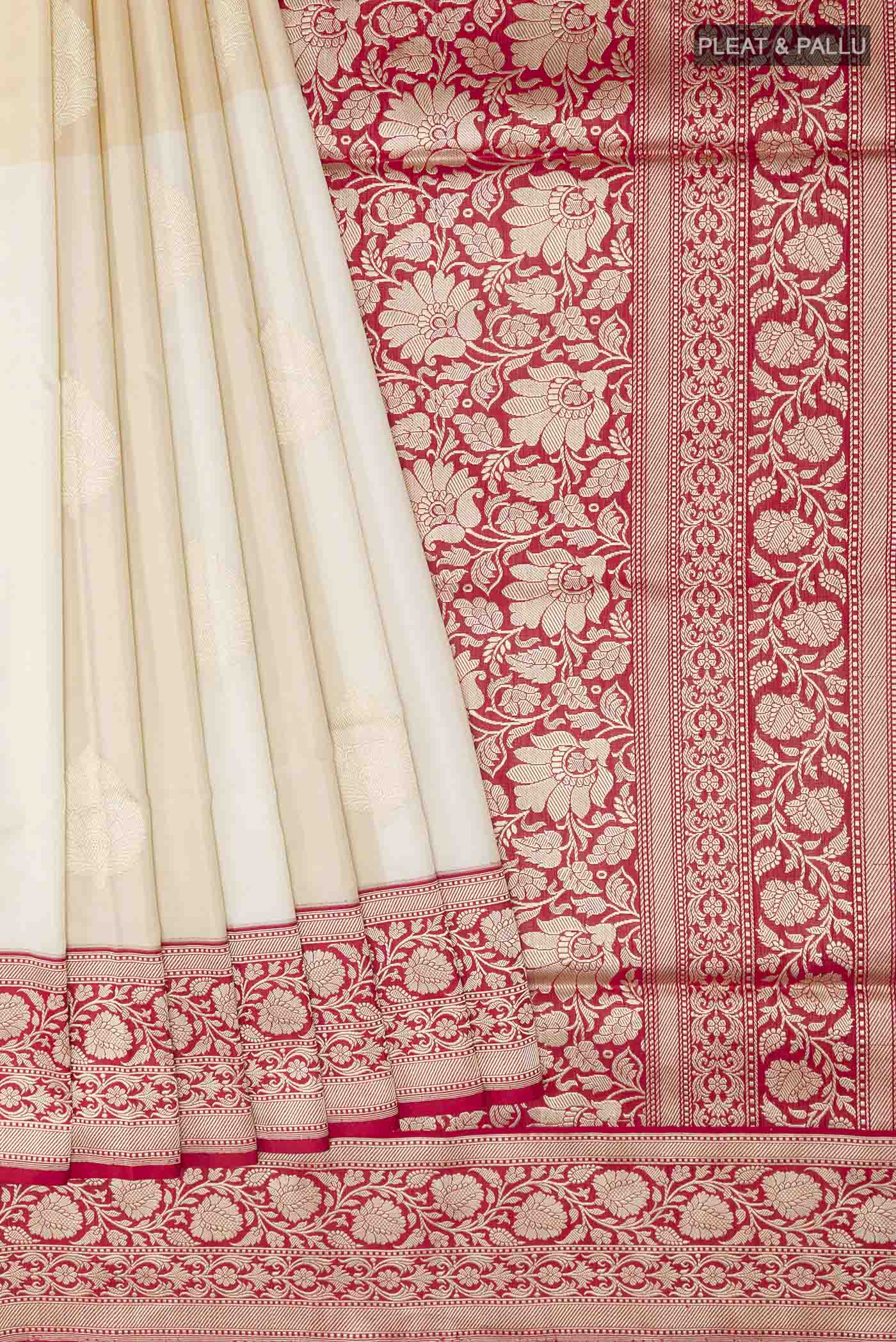 Pleats and pallu of Off White Banarasi Silk Saree with Zari Butta on the body and Zari Border