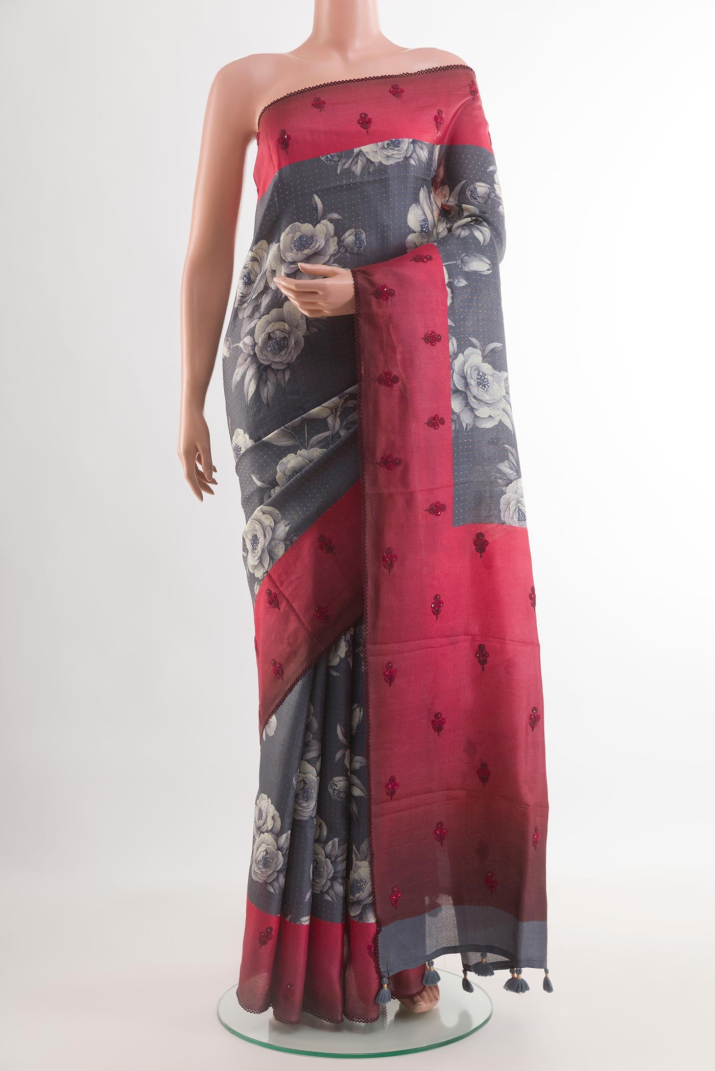 Grey Tussar Silk Saree with Printed design on the body and Embroidery Border.  displayed on a mannequin