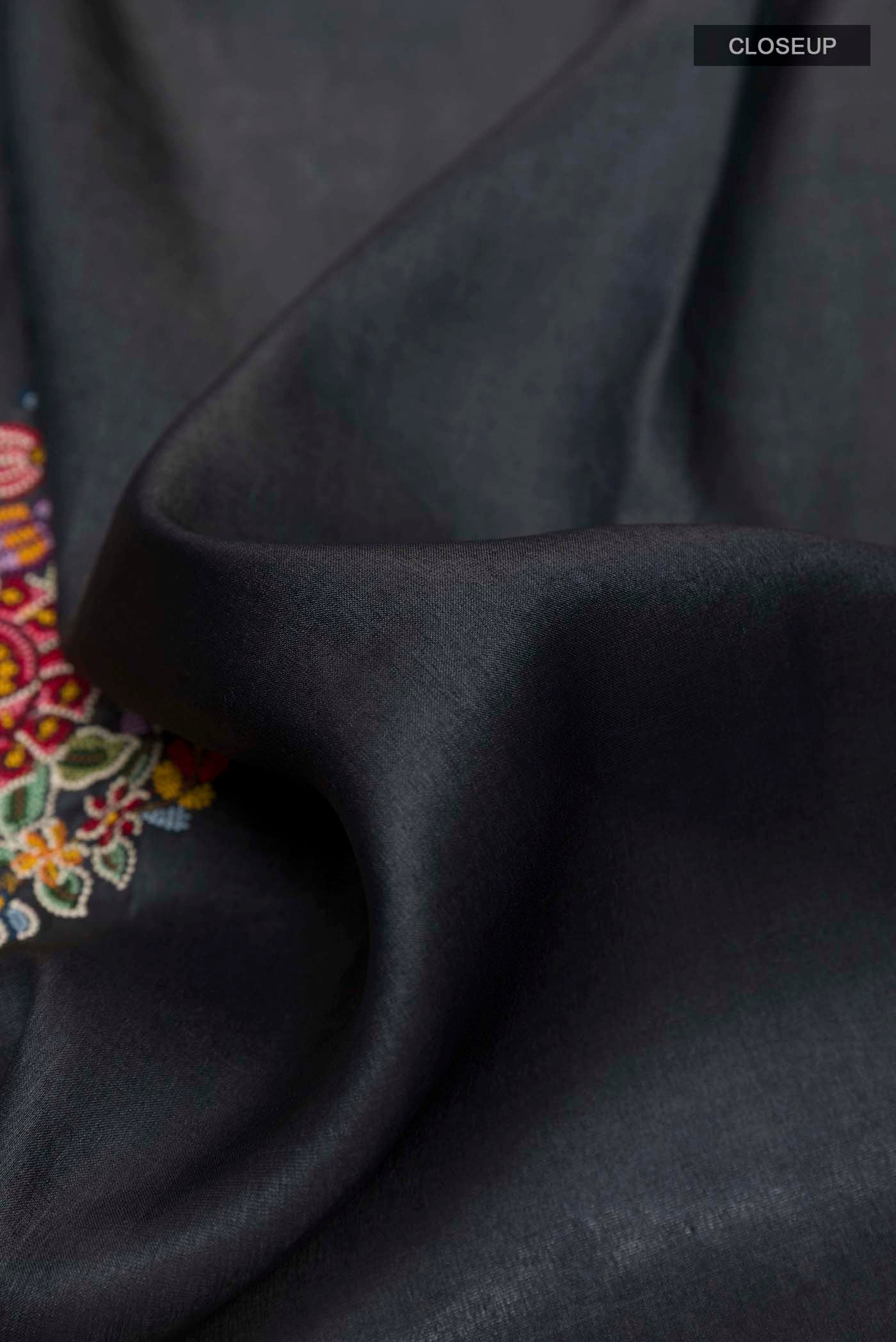 Close up of Black Tussar Saree with Thread Butta on the body and Zari Border displaying folds