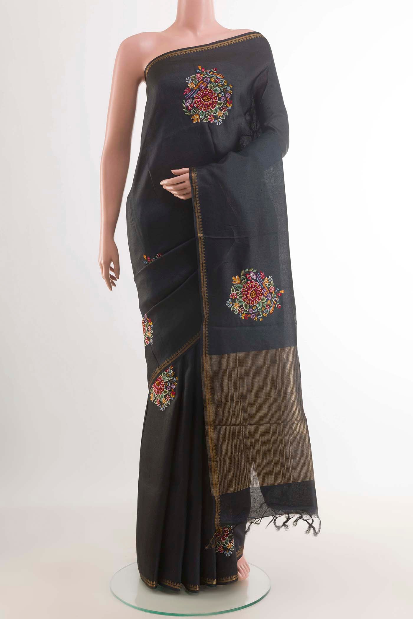Black Tussar Saree with Thread Butta on the body and Zari Border displayed on a mannequin