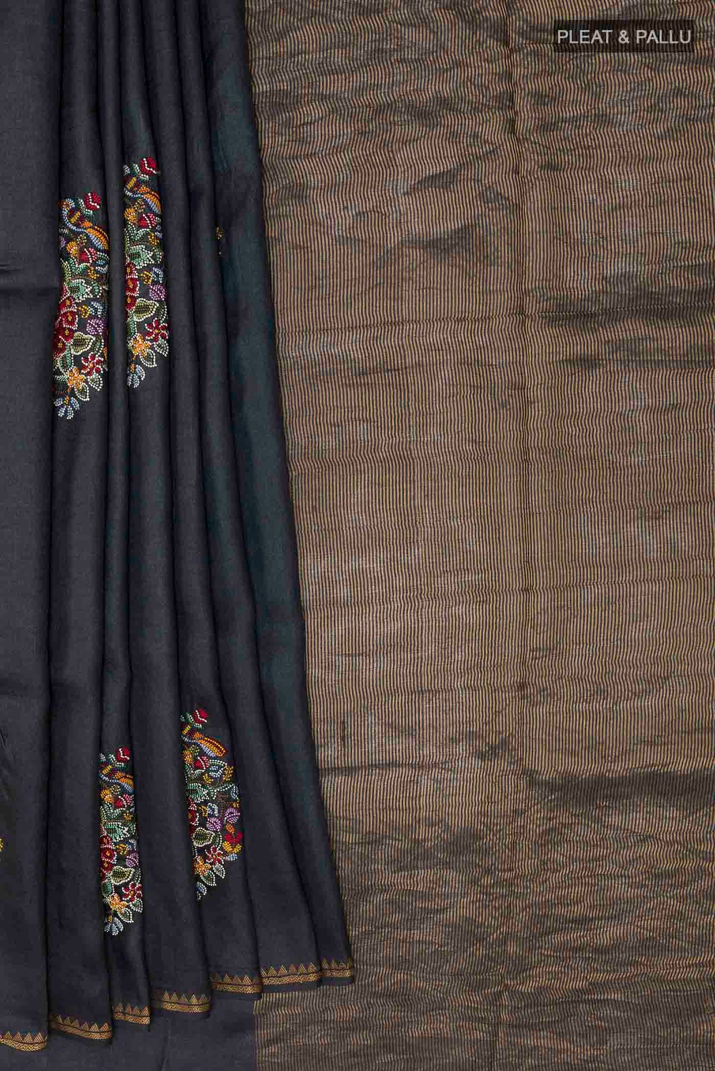 Pleats and pallu of Black Tussar Saree with Thread Butta on the body and Zari Border