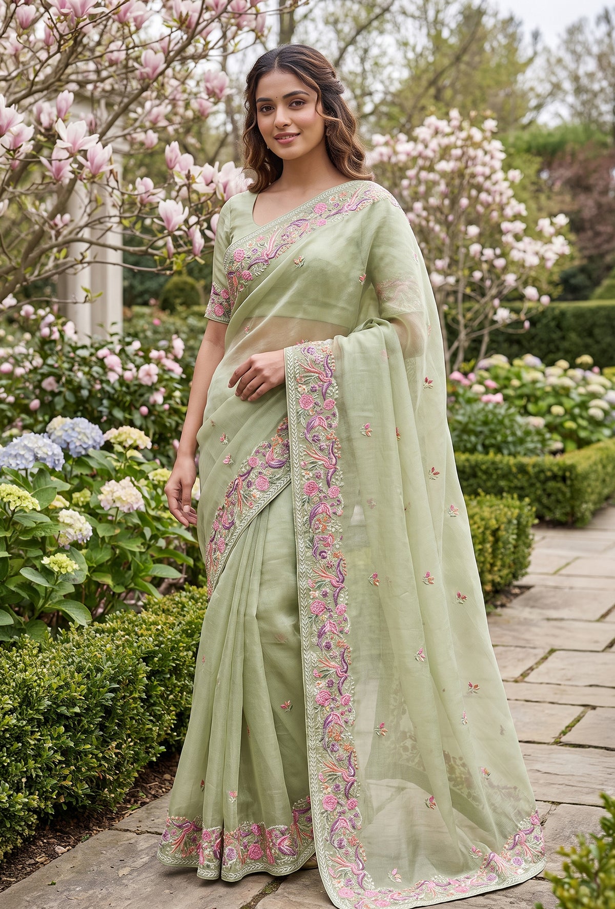 Model wearing a Sage Green Tussar Saree with Thread Butta on the body and Embroidery Border.