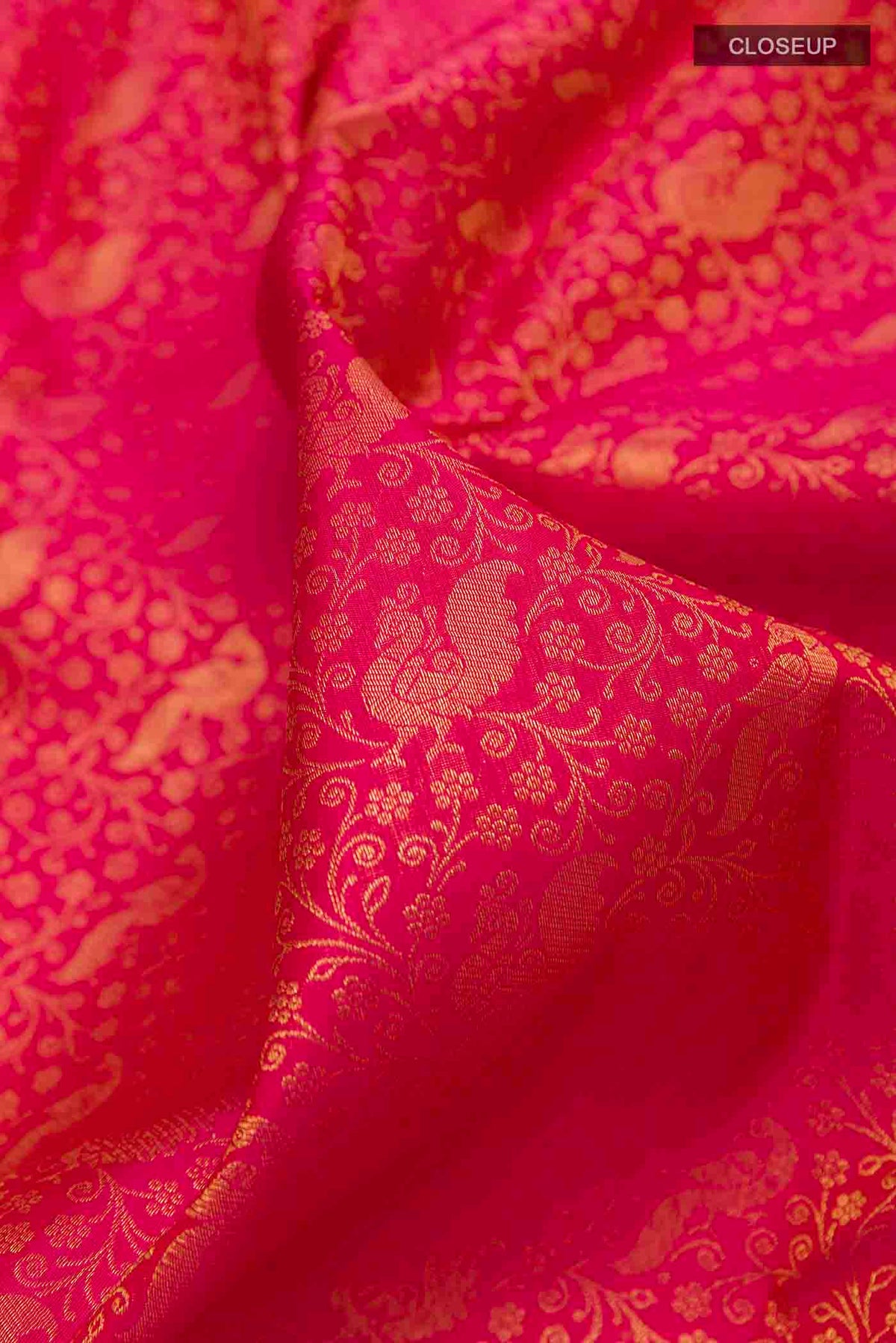 Close up of Pure Silk Pure Zari Pink Kanchipuram Saree with Zari Brocade on the body and Zari Border displaying folds