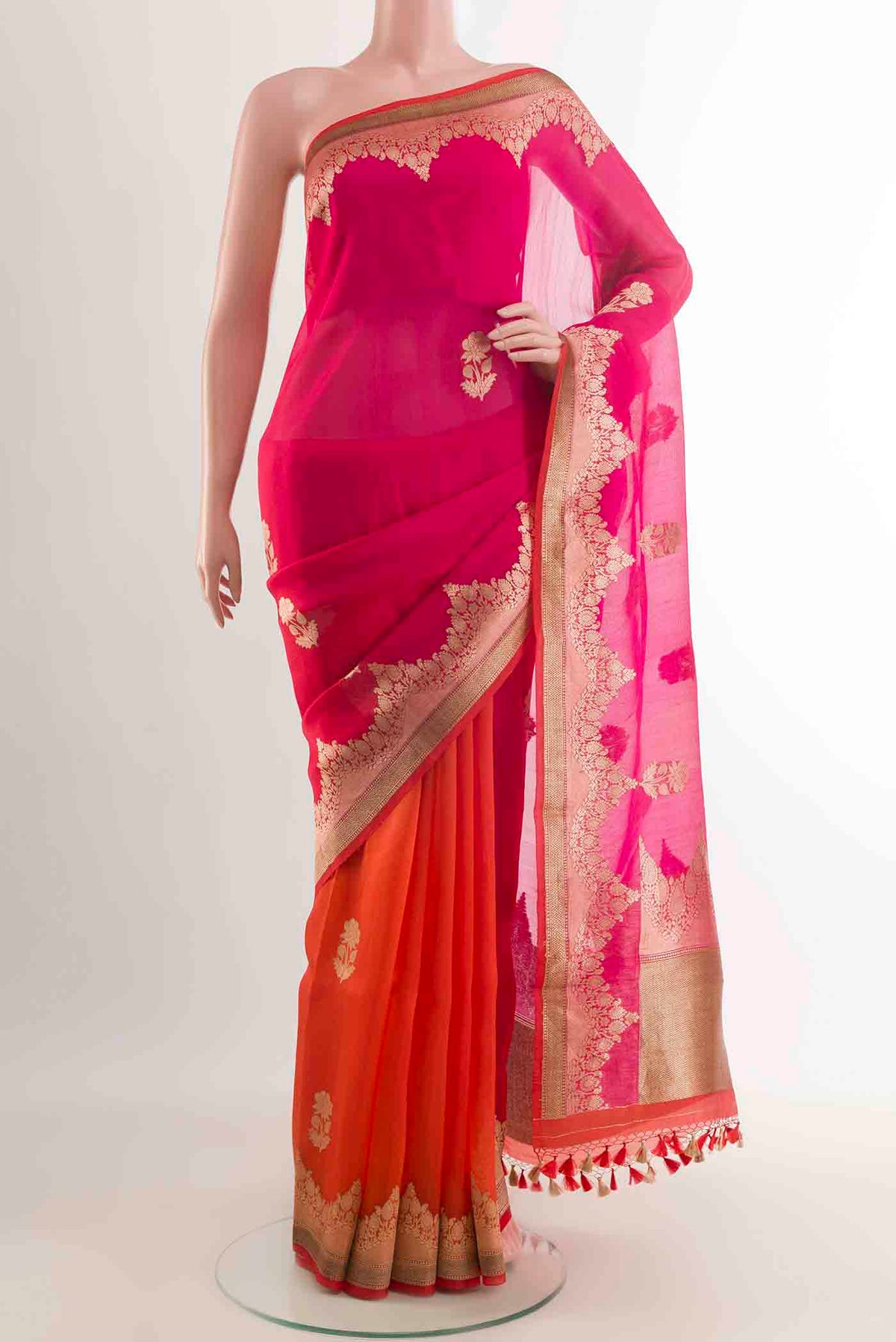 Orange Organza Silk Saree with Zari Butta on the body and Zari Border displayed on a mannequin