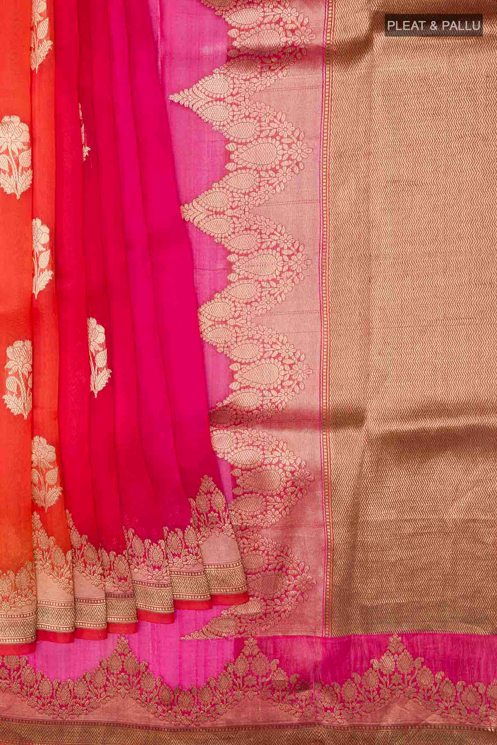Pleats and pallu of Orange Organza Silk Saree with Zari Butta on the body and Zari Border