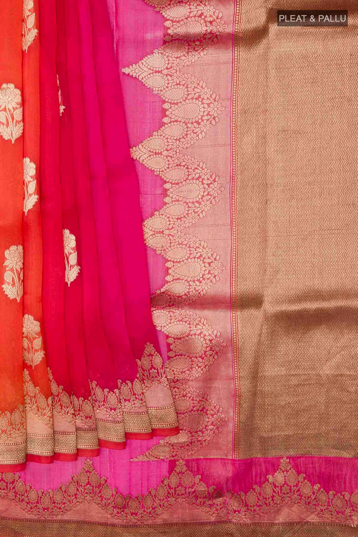 Pleats and pallu of Orange Organza Silk Saree with Zari Butta on the body and Zari Border