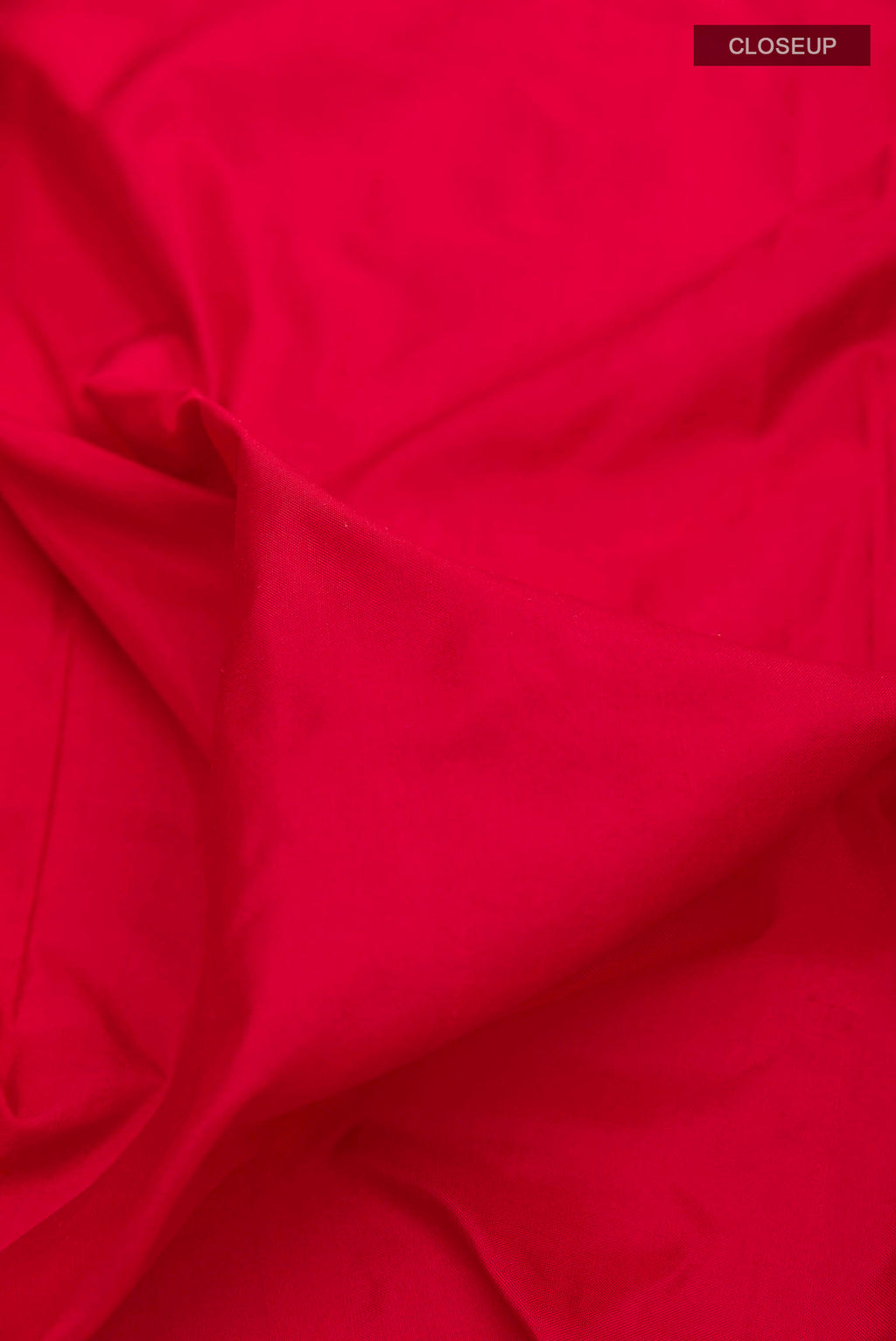 Close up of Red Pochampally Silk Saree with Plain Body and Ikat Border displaying folds