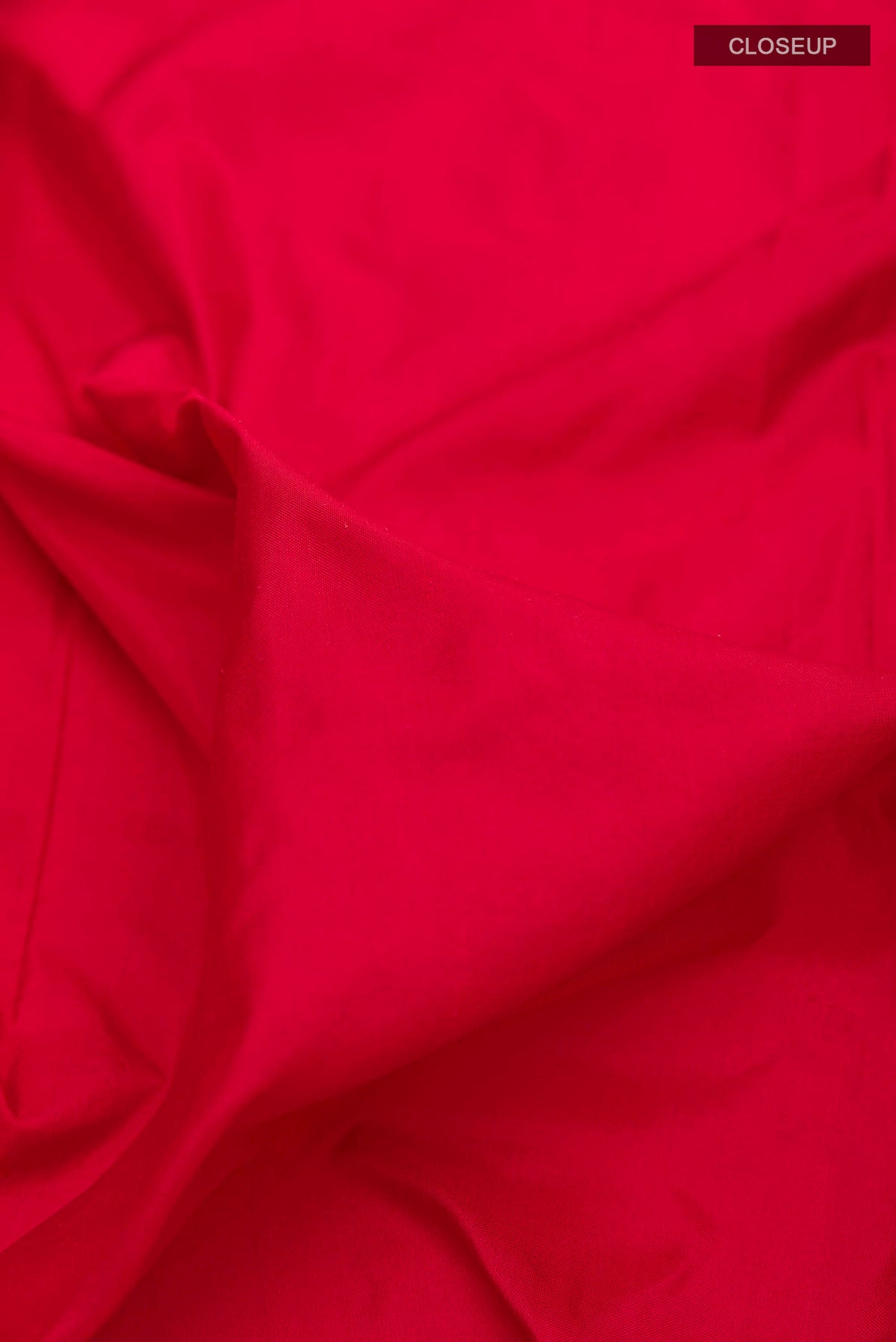 Close up of Red Pochampally Silk Saree with Plain Body and Ikat Border displaying folds