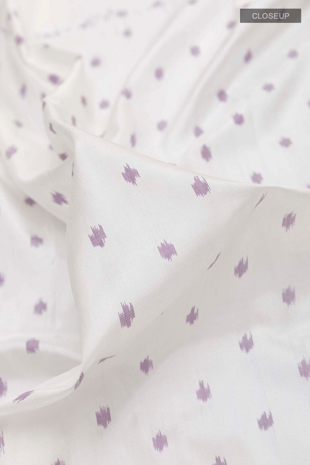 Close up of White Pochampally Silk Saree with Pure Ikat on the body and Ikat Border displaying folds