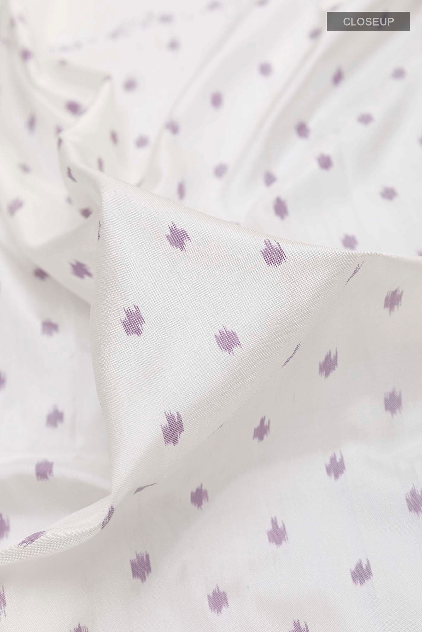 Close up of White Pochampally Silk Saree with Pure Ikat on the body and Ikat Border displaying folds