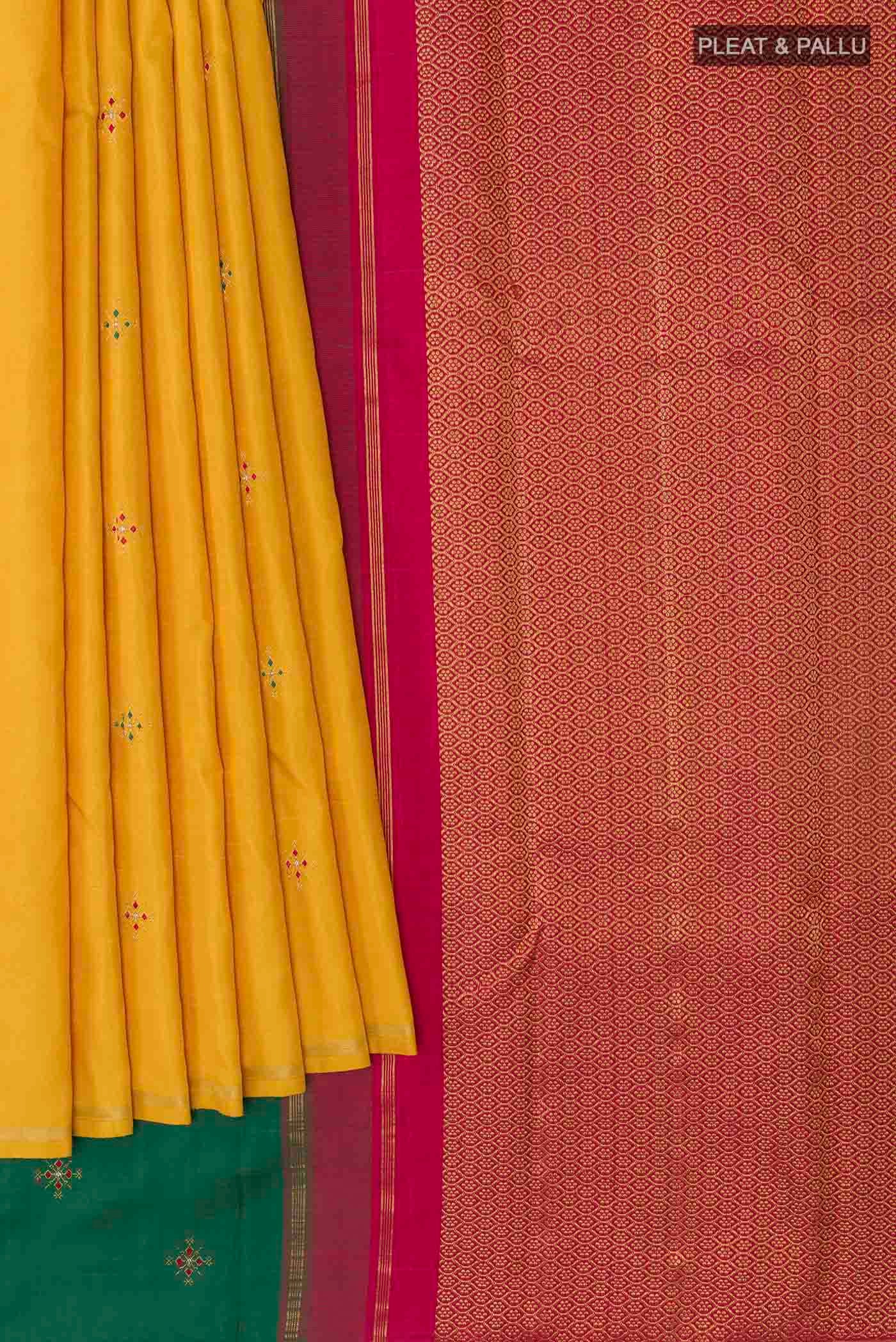 Pleats and pallu of Mustard Kanchipuram Silk Saree with Zari Butta on the body and Zari Border