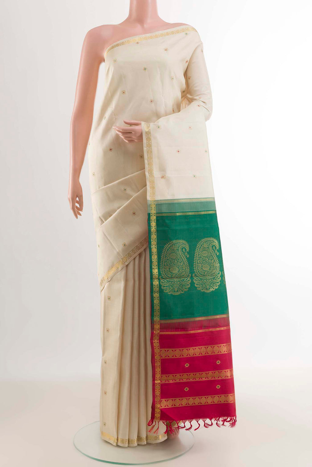 Off White Kanchipuram Silk Saree with Zari Butta on the body and Zari Border displayed on a mannequin