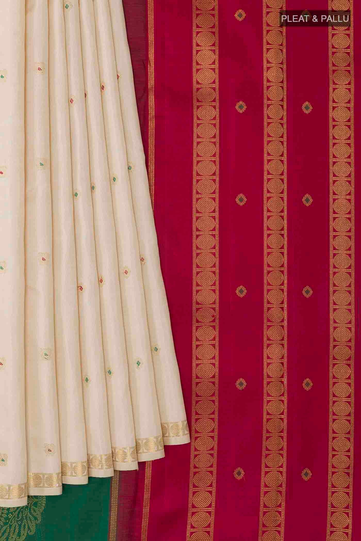 Pleats and pallu of Off White Kanchipuram Silk Saree with Zari Butta on the body and Zari Border