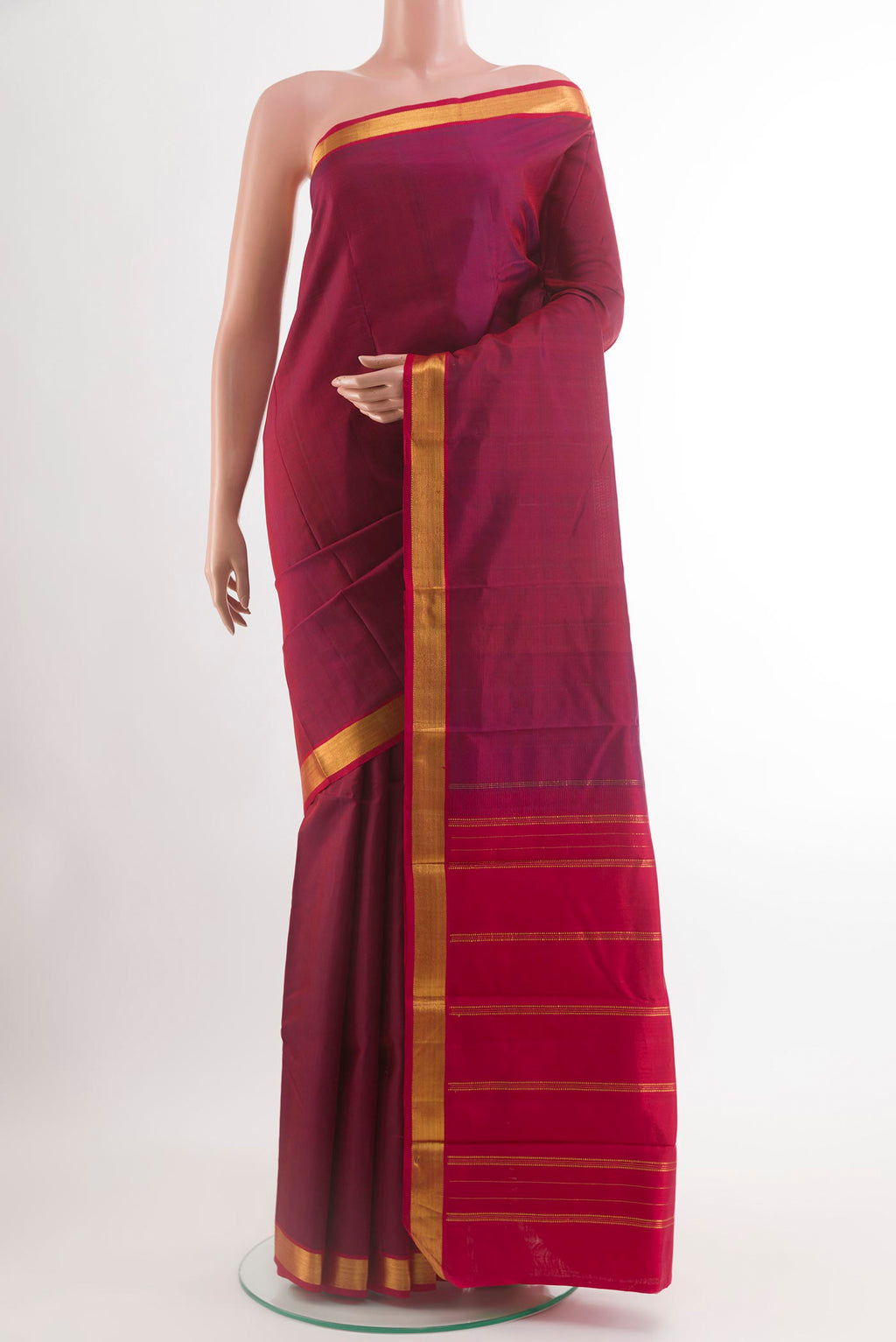 Magenta Kanjivaram Silk Saree with Plain Body and Zari Border.  displayed on a mannequin