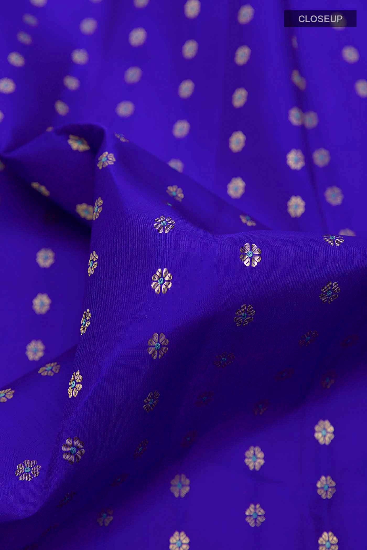 Close up of Blue Kanchipuram Silk Saree with Zari Butta on the body and Zari Border displaying folds