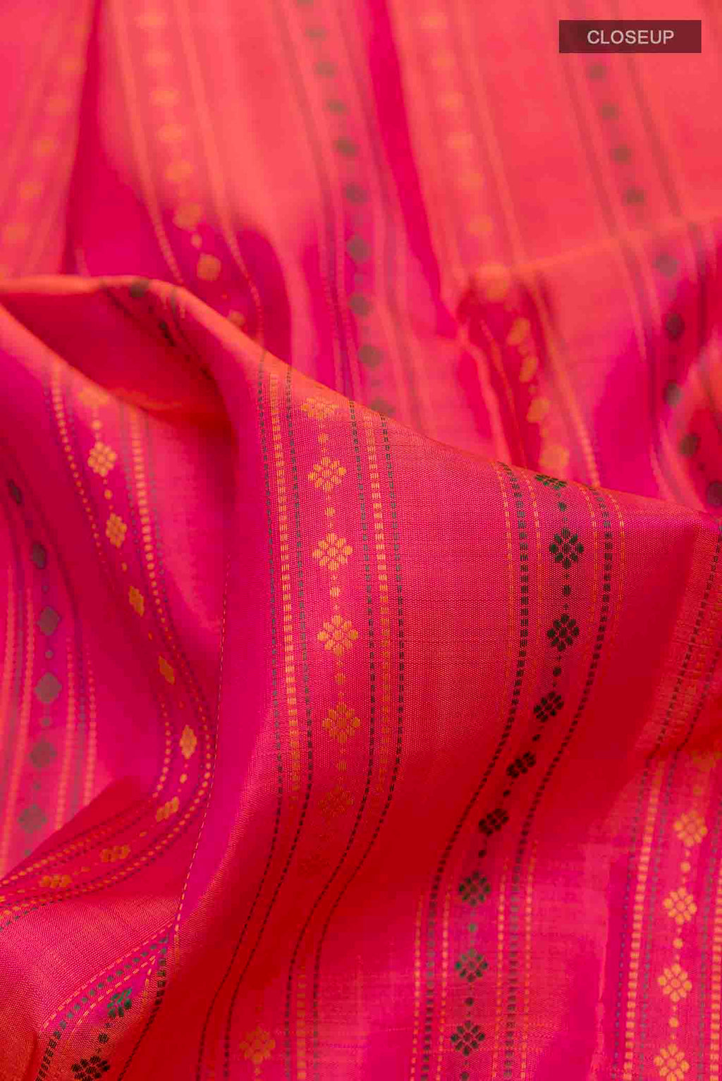 Close up of Pink with Orange Color Kanchipuram Silk Saree with Stripes on the body and Zari Border displaying folds