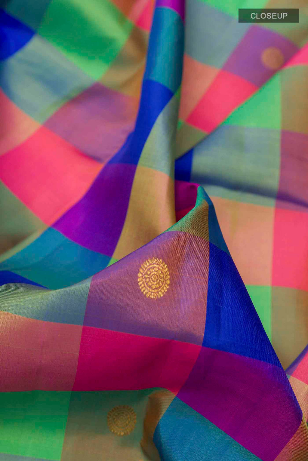 Close up of Multi Color Kanchipuram Silk Saree with Checked design on the body and Zari Border displaying folds