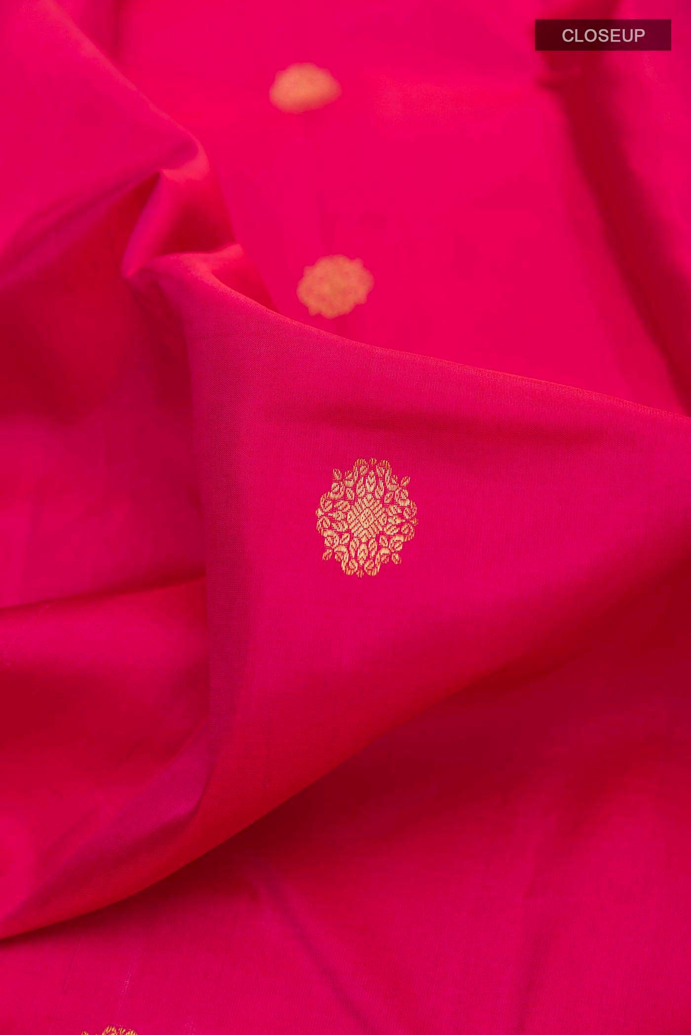 Close up of Pure Silk Pure Zari Pink Dual Tone Kanchipuram Saree with Zari Butta on the body and Zari Border displaying folds