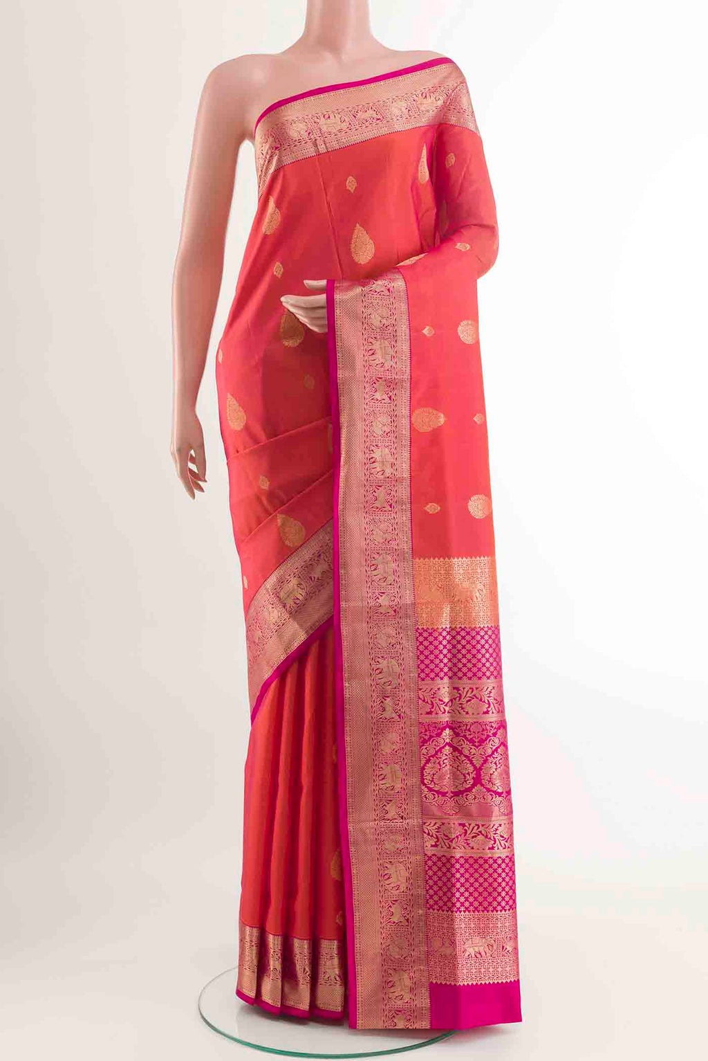 Peach Soft Silk Saree with Zari Butta on the body and Zari Border displayed on a mannequin