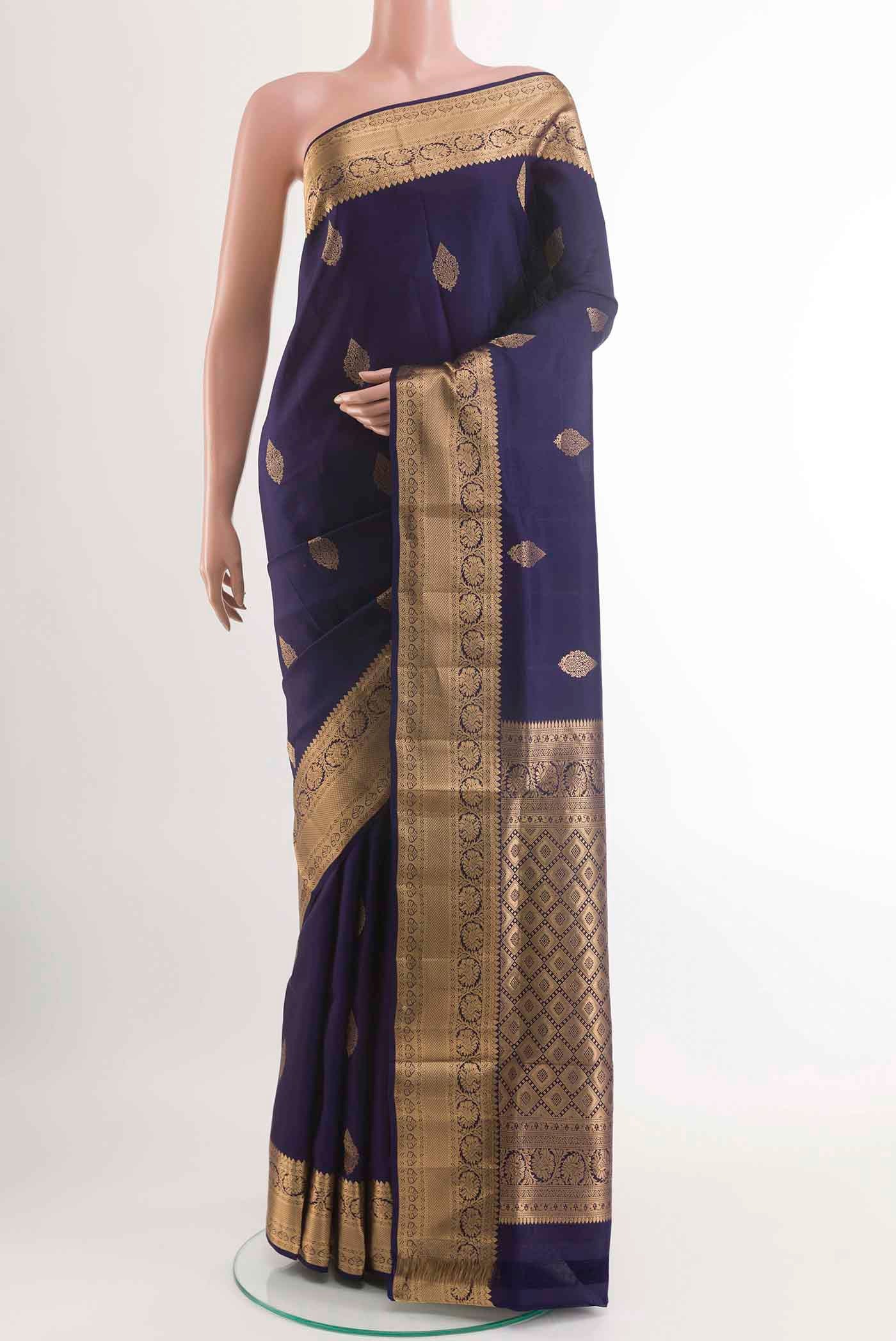 Navy Blue Soft Silk Saree with Zari Butta on the body and Zari Border displayed on a mannequin