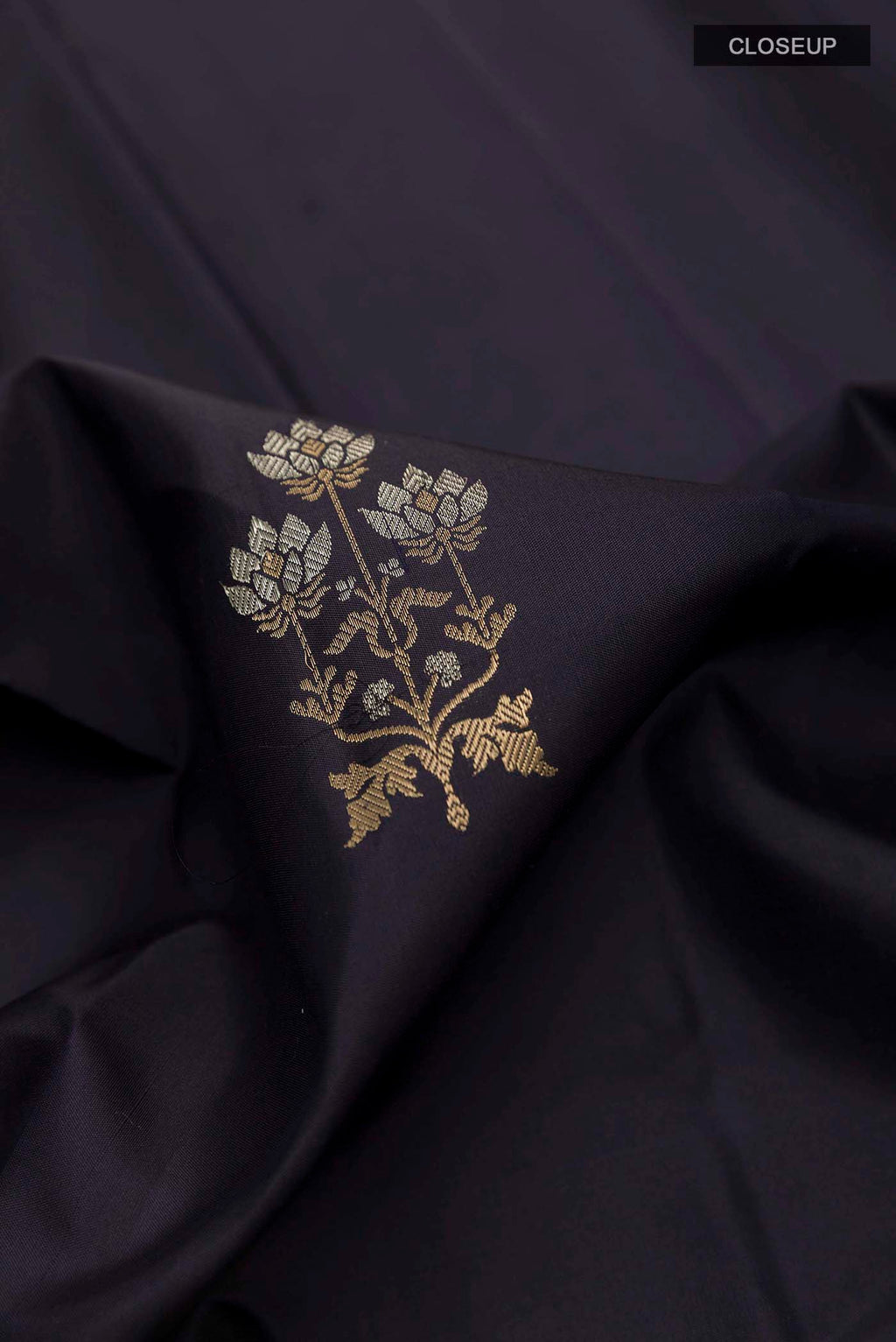 Close up of Dark Blue Kanchipuram Silk Saree with Zari Butta on the body and Zari Border displaying folds