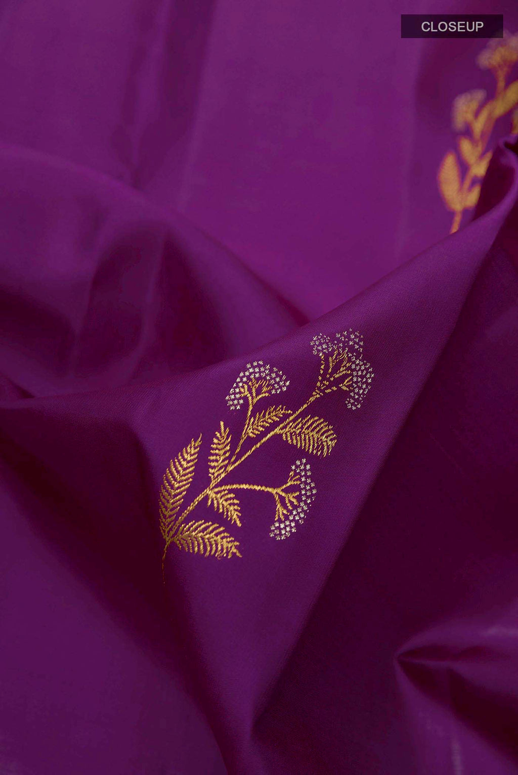 Close up of Dark Blue Kanchipuram Silk Saree with Zari Butta on the body and Zari Border displaying folds