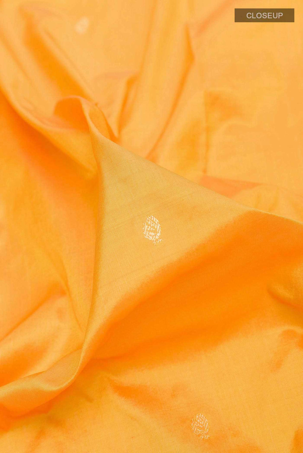 Close up of Yellow Dual Tone Paithani Silk Saree with Zari Butta on the body and Zari Border displaying folds