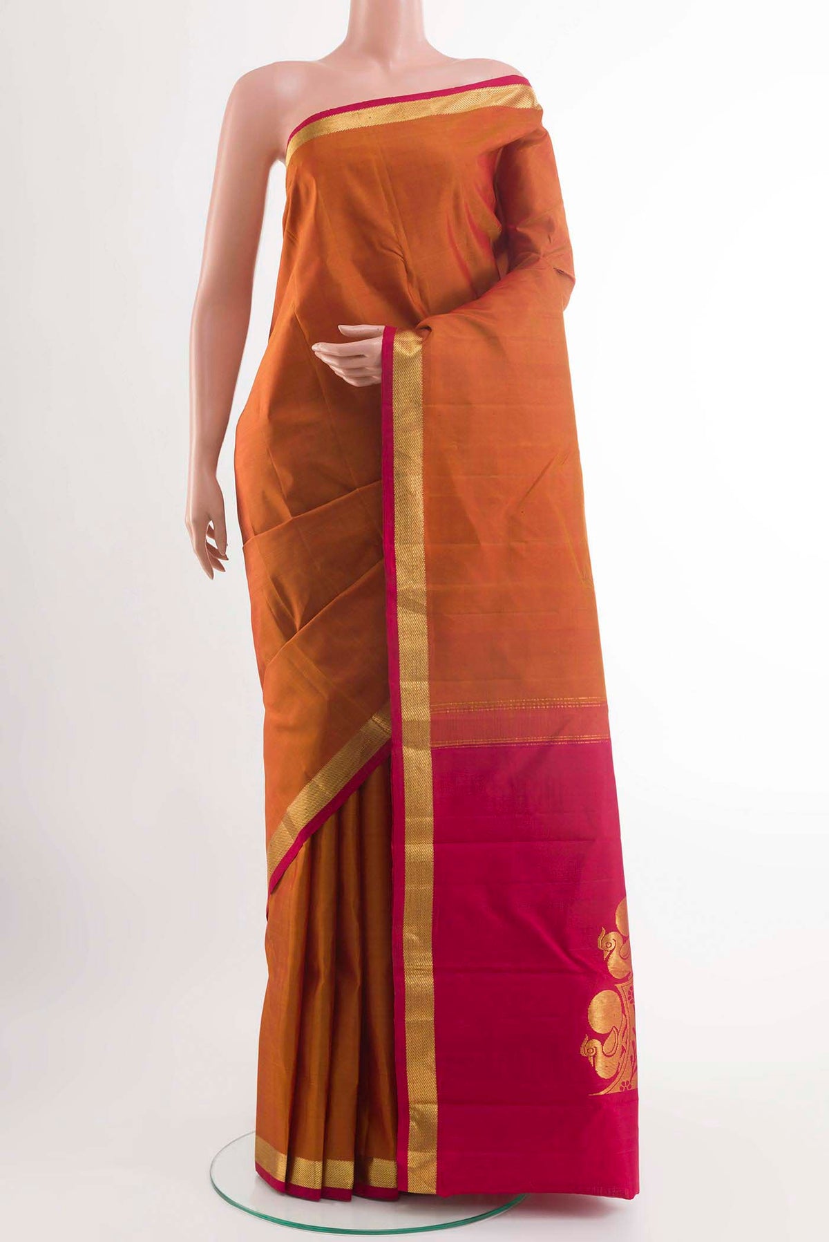 Brick Orange Kanchipuram Silk Saree with Plain Body and Zari Border displayed on a mannequin