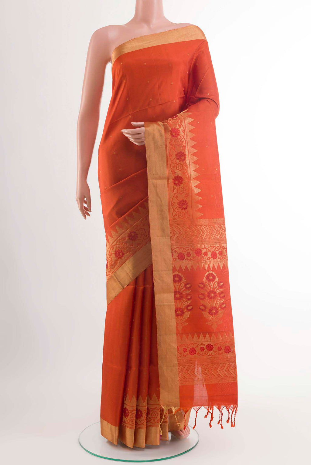 Orange Soft Silk Saree with Zari Butta on the body and Zari Border displayed on a mannequin