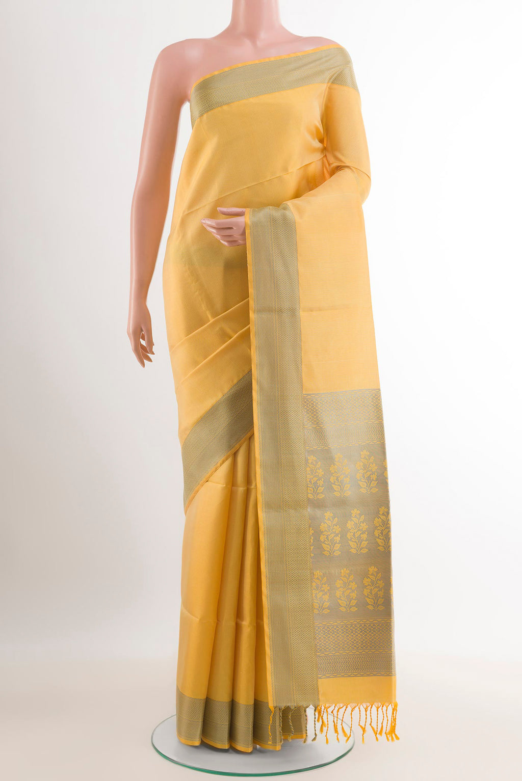 Yellow Soft Silk Saree with Jacquard design on the body and Zari Border.  displayed on a mannequin