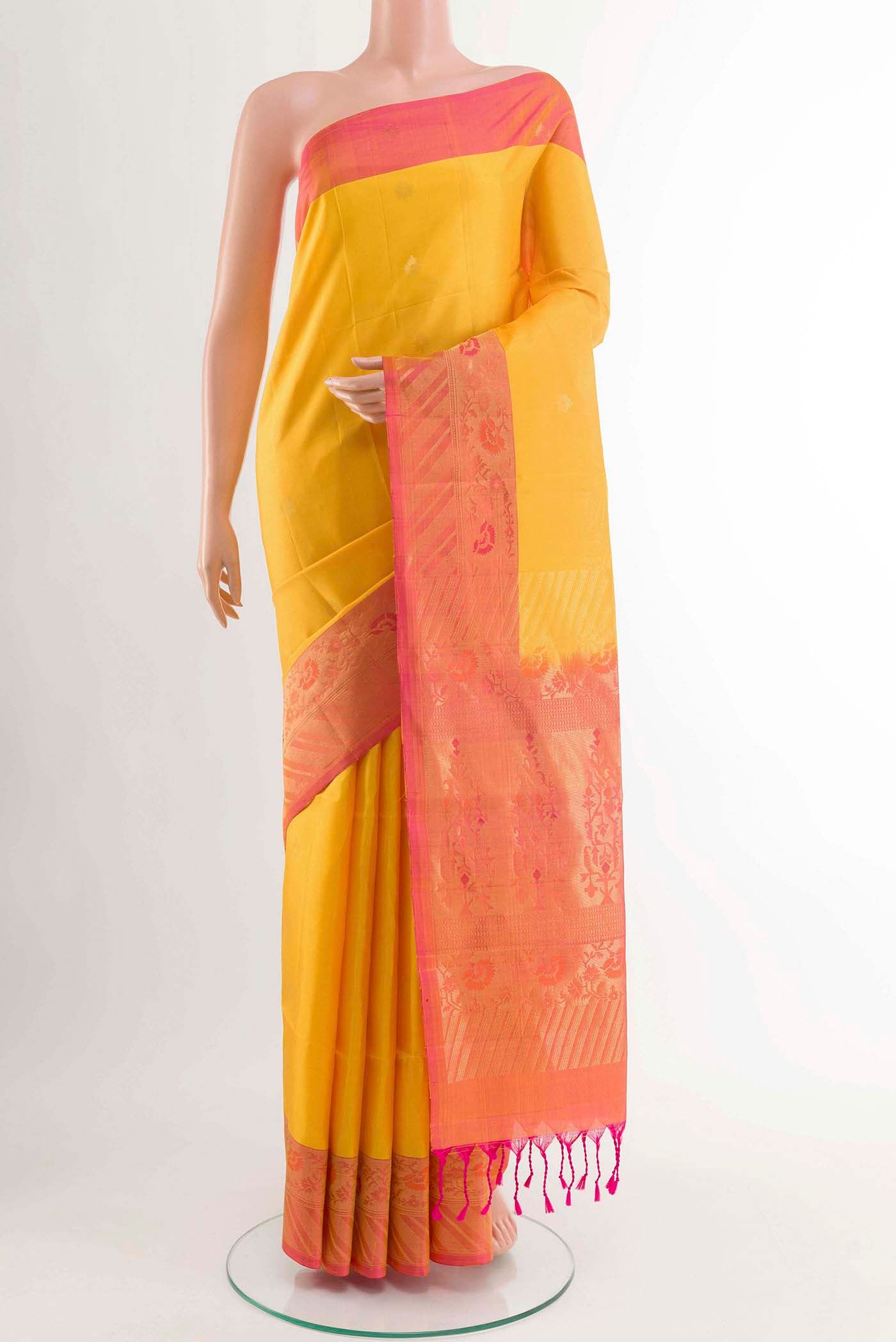 Yellow Soft Silk Saree with Zari Butta on the body and Zari Border displayed on a mannequin