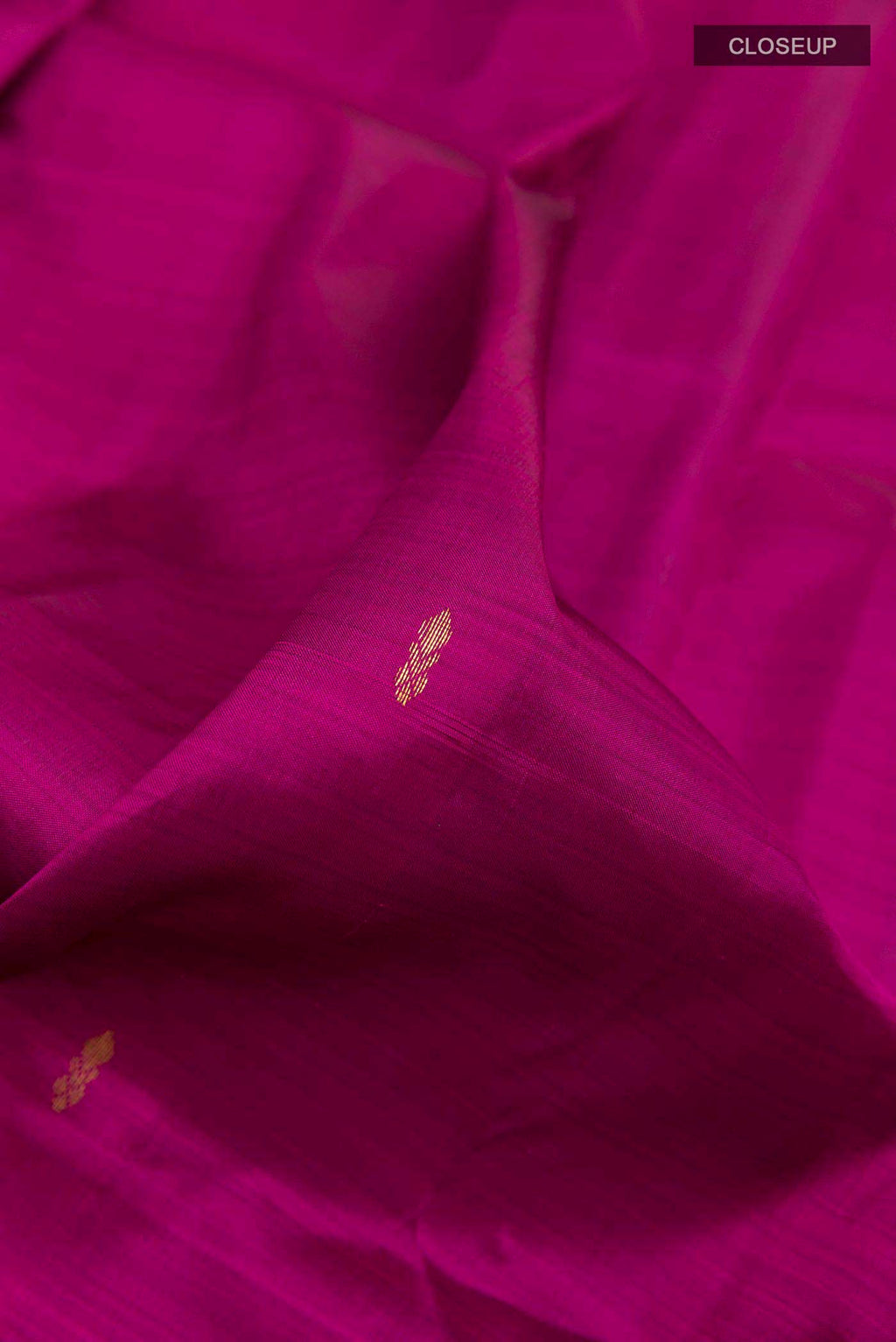 Close up of Purple Kanchipuram Silk Saree with Zari Butta on the body and Zari Border displaying folds
