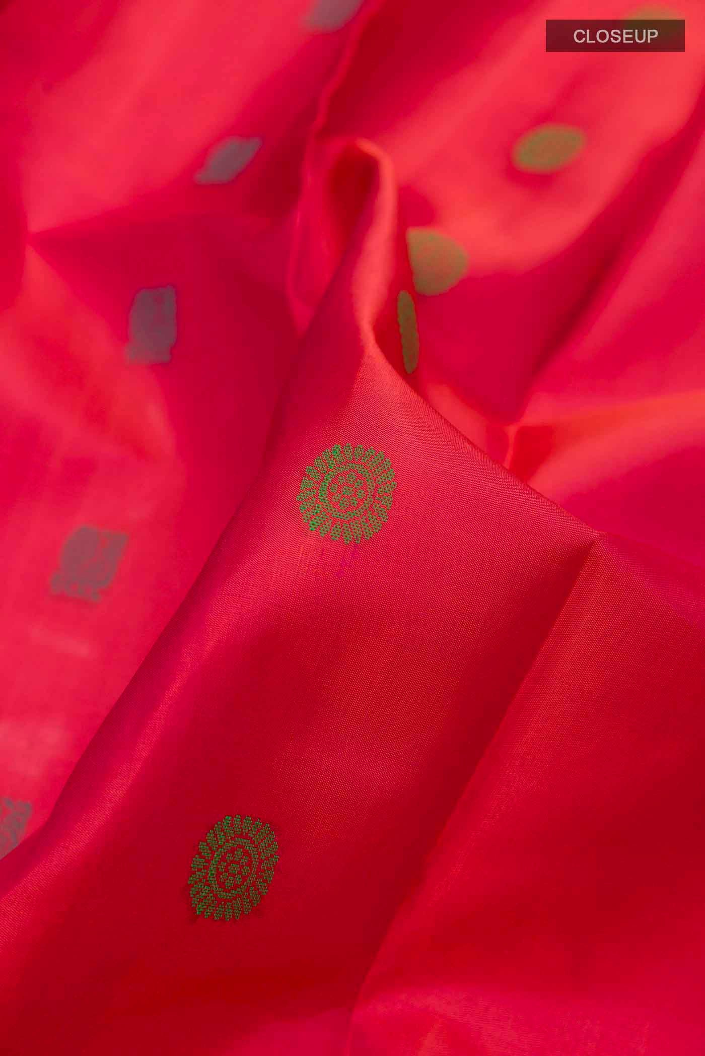 Close up of Pink Kanchipuram Silk Saree with Thread Butta on the body and Without Border displaying folds