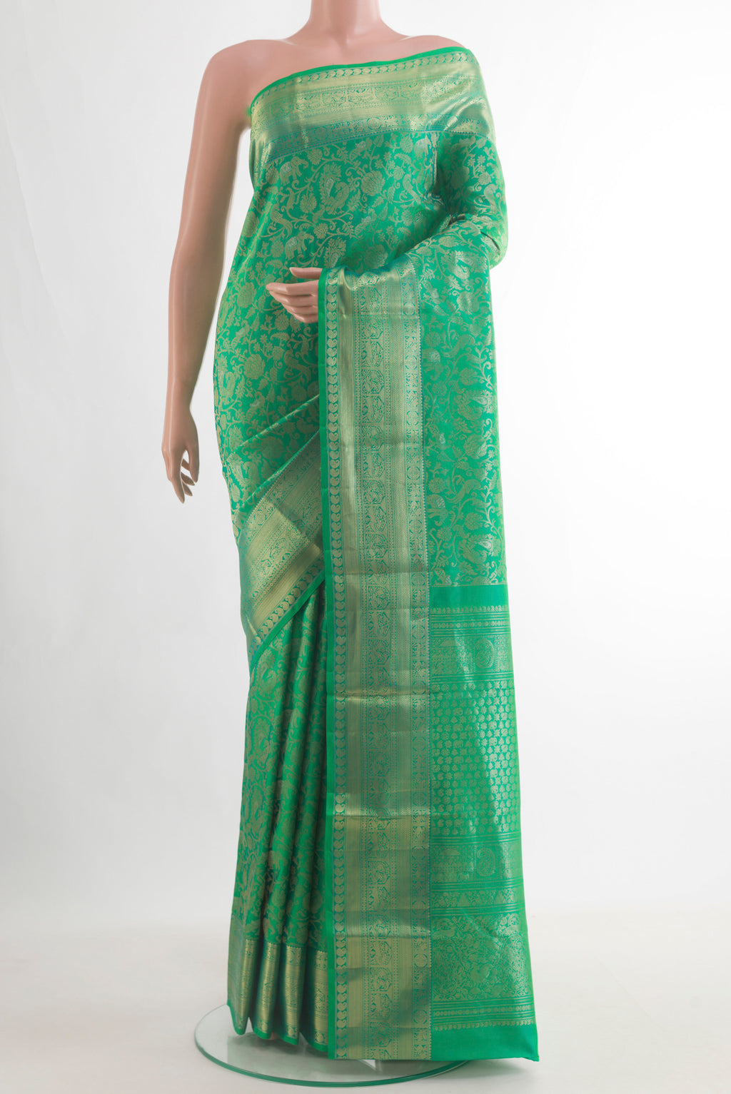 Pure Silk Green Kanjivaram Saree with Zari Brocade on the body and Zari Border.  displayed on a mannequin