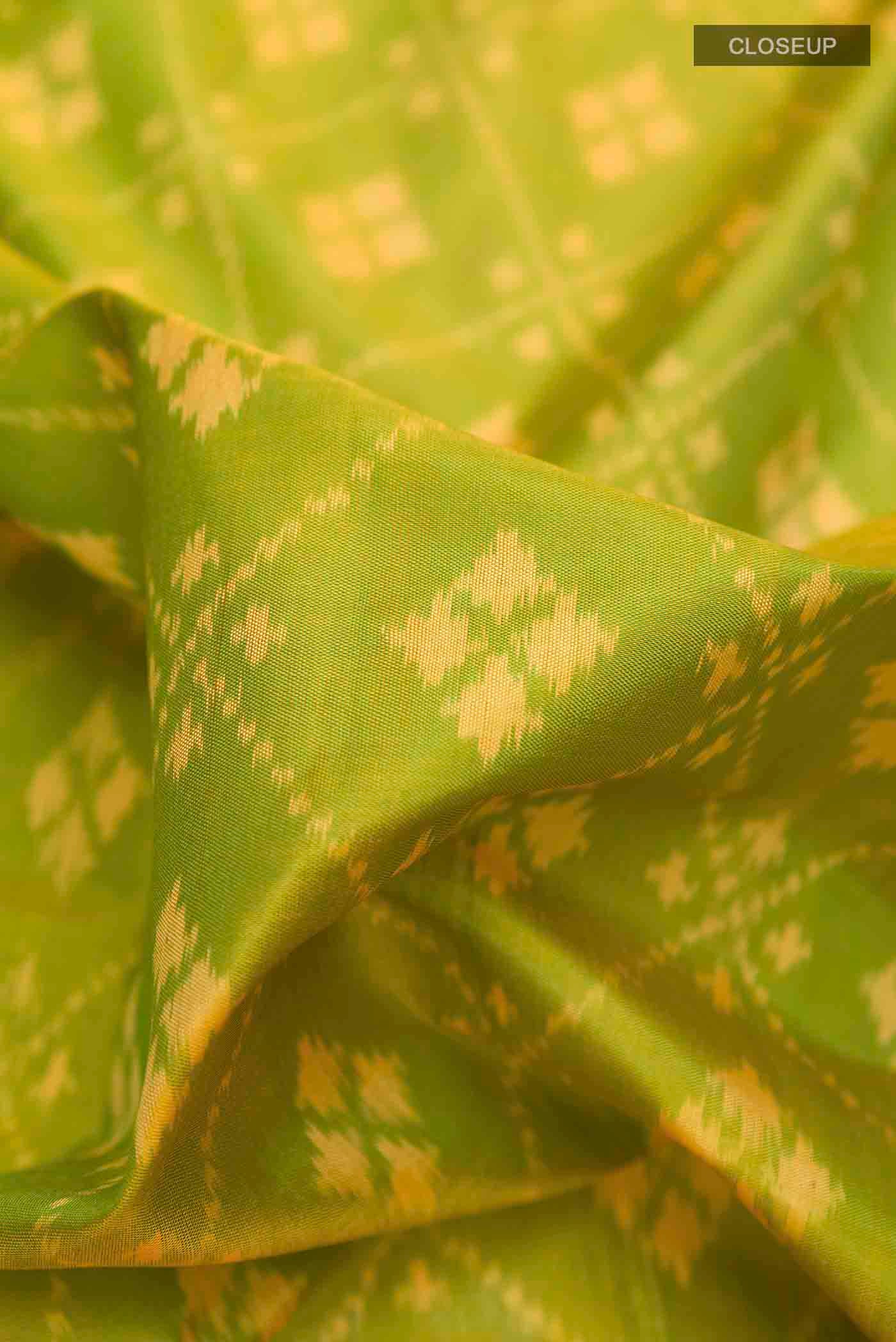 Close up of Green Rajkot Patola Silk Saree with Pure Ikat on the body and Zari Border displaying folds