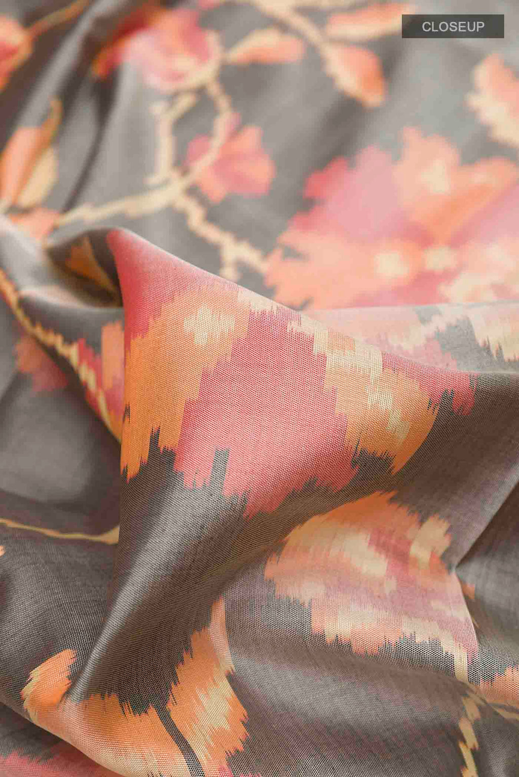 Close up of Grey Rajkot Patola Silk Saree with Pure Ikat on the body and Zari Border displaying folds