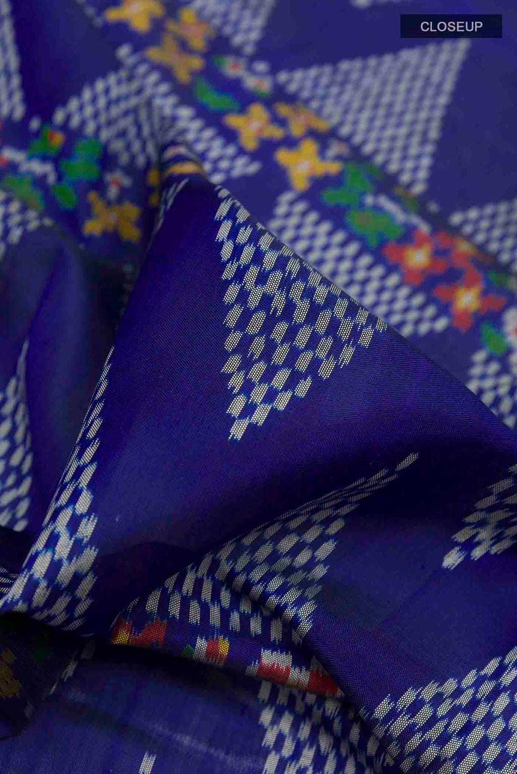 Close up of Blue Rajkot Patola Silk Saree with Pure Ikat on the body and Zari Border displaying folds