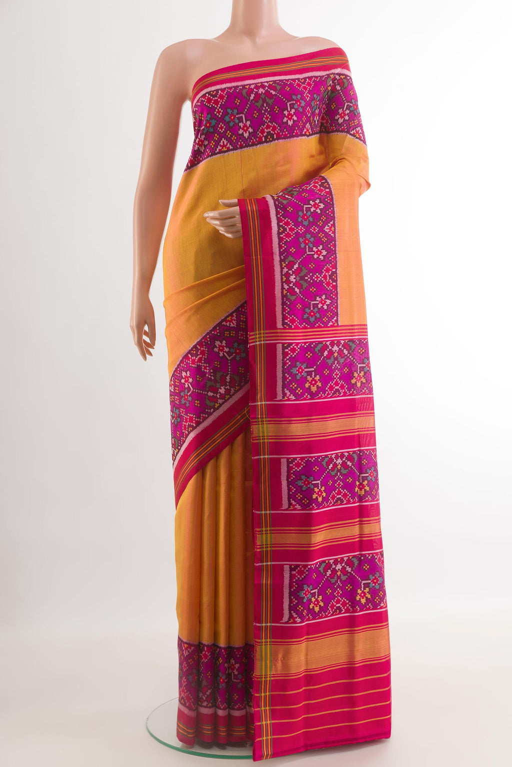 Mustard Rajkot Patola Silk Saree with Plain Body and Ikat Border.  displayed on a mannequin
