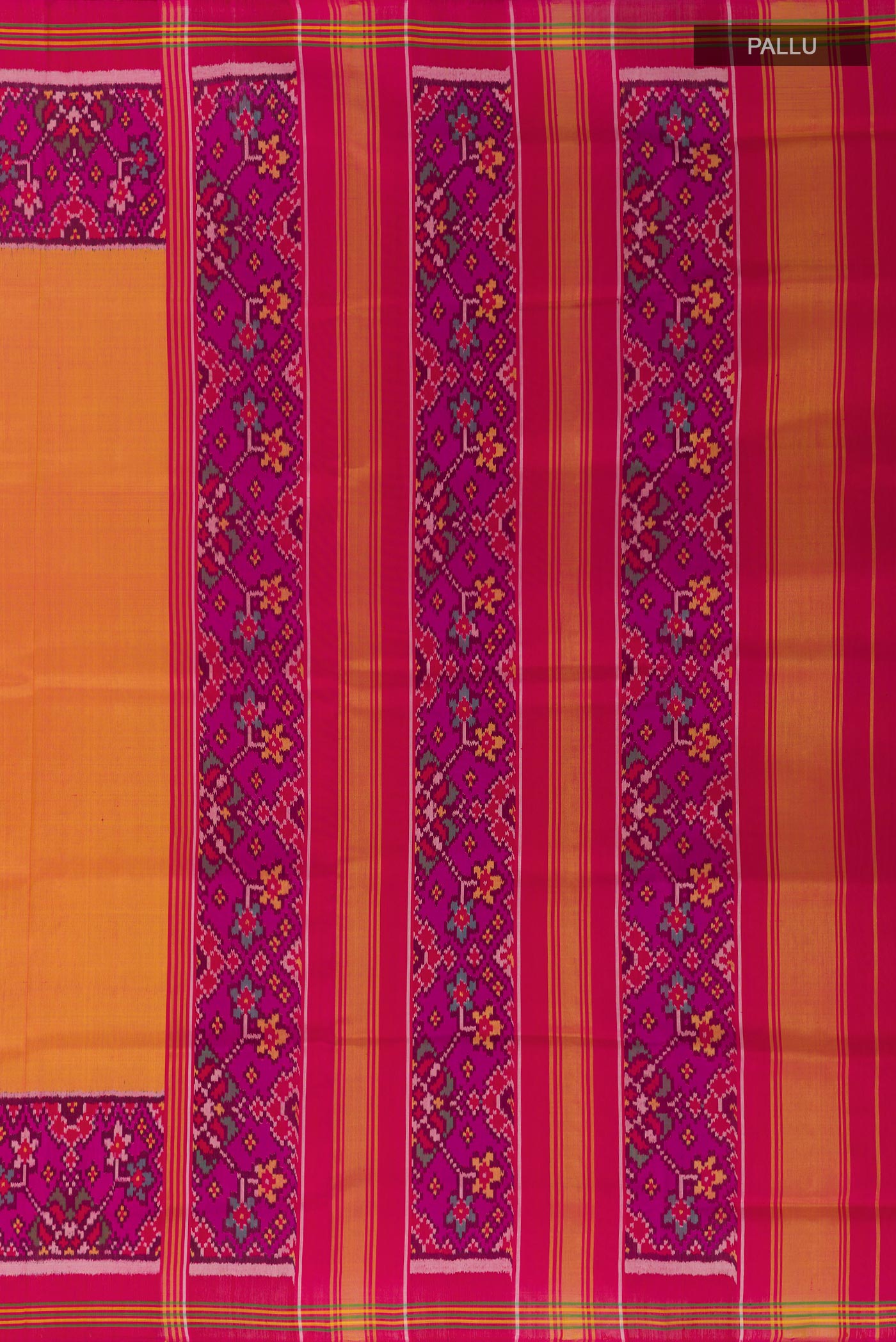 Close up image of the pallu of Mustard Rajkot Patola Silk Saree with Plain Body and Ikat Border. 