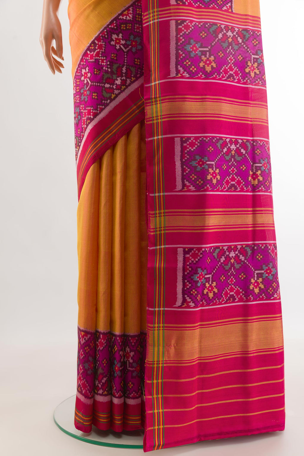 Pleats and pallu of Mustard Rajkot Patola Silk Saree with Plain Body and Ikat Border. 