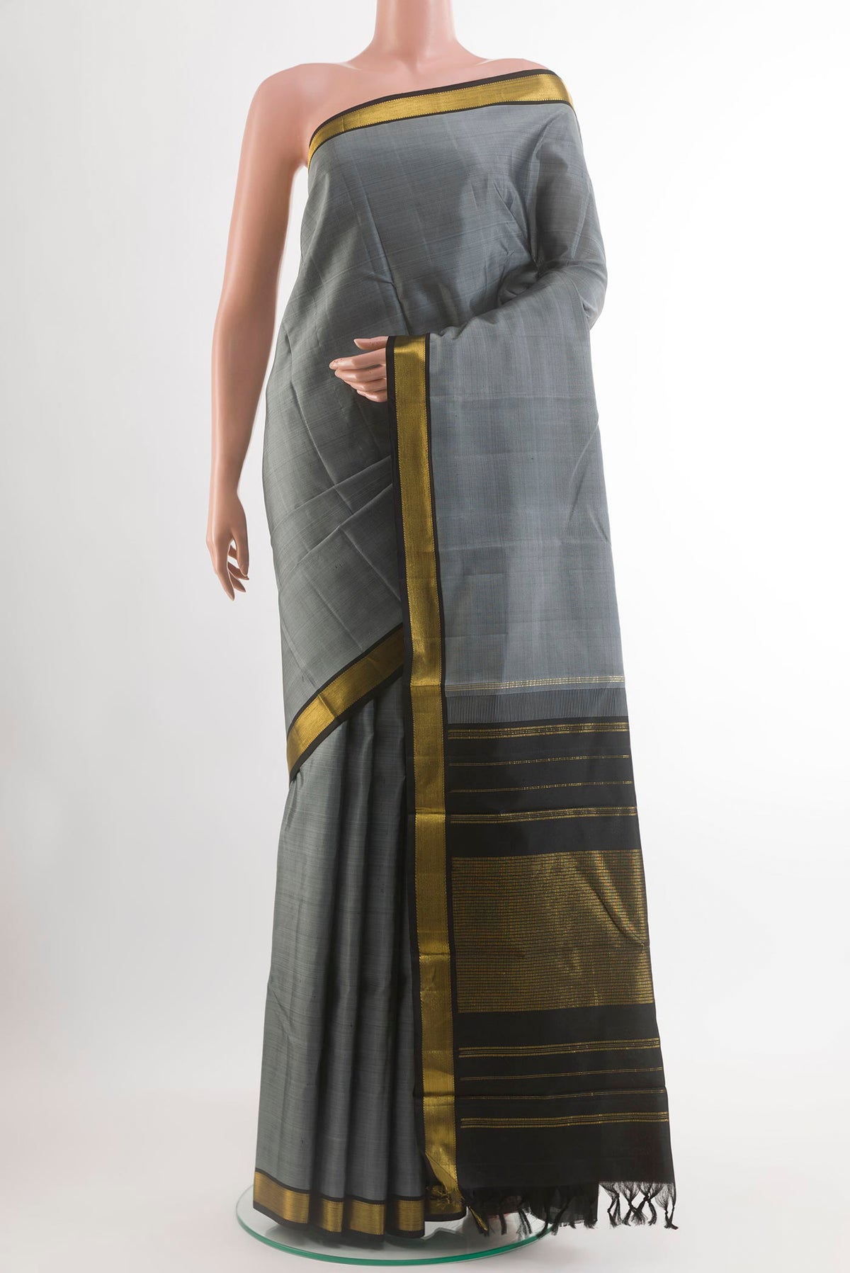 Grey Kanjivaram Silk Saree with Plain Body and Zari Border.  displayed on a mannequin