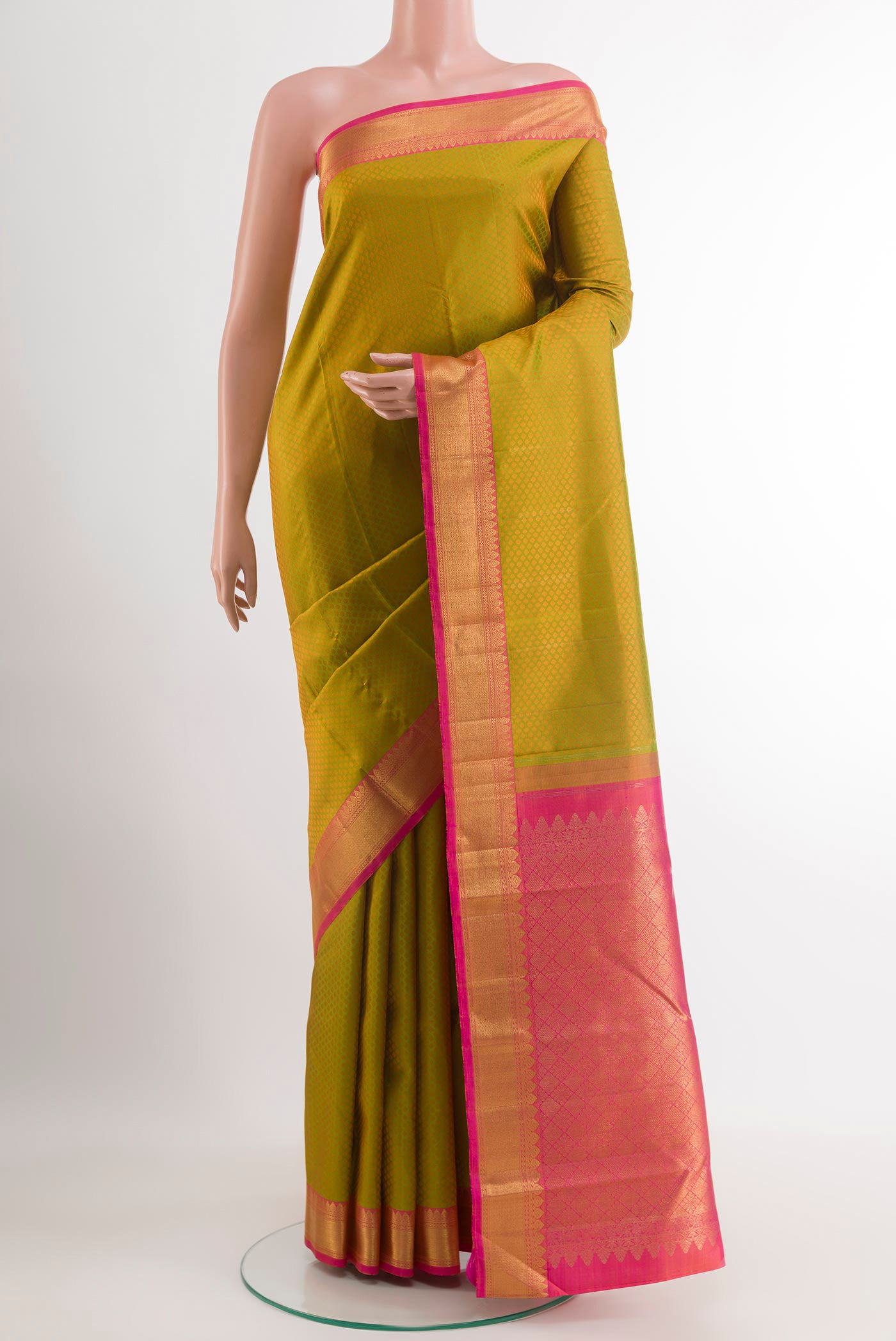 Green Kanchipuram Silk Saree with Jacquard design on the body and Zari Border.  displayed on a mannequin