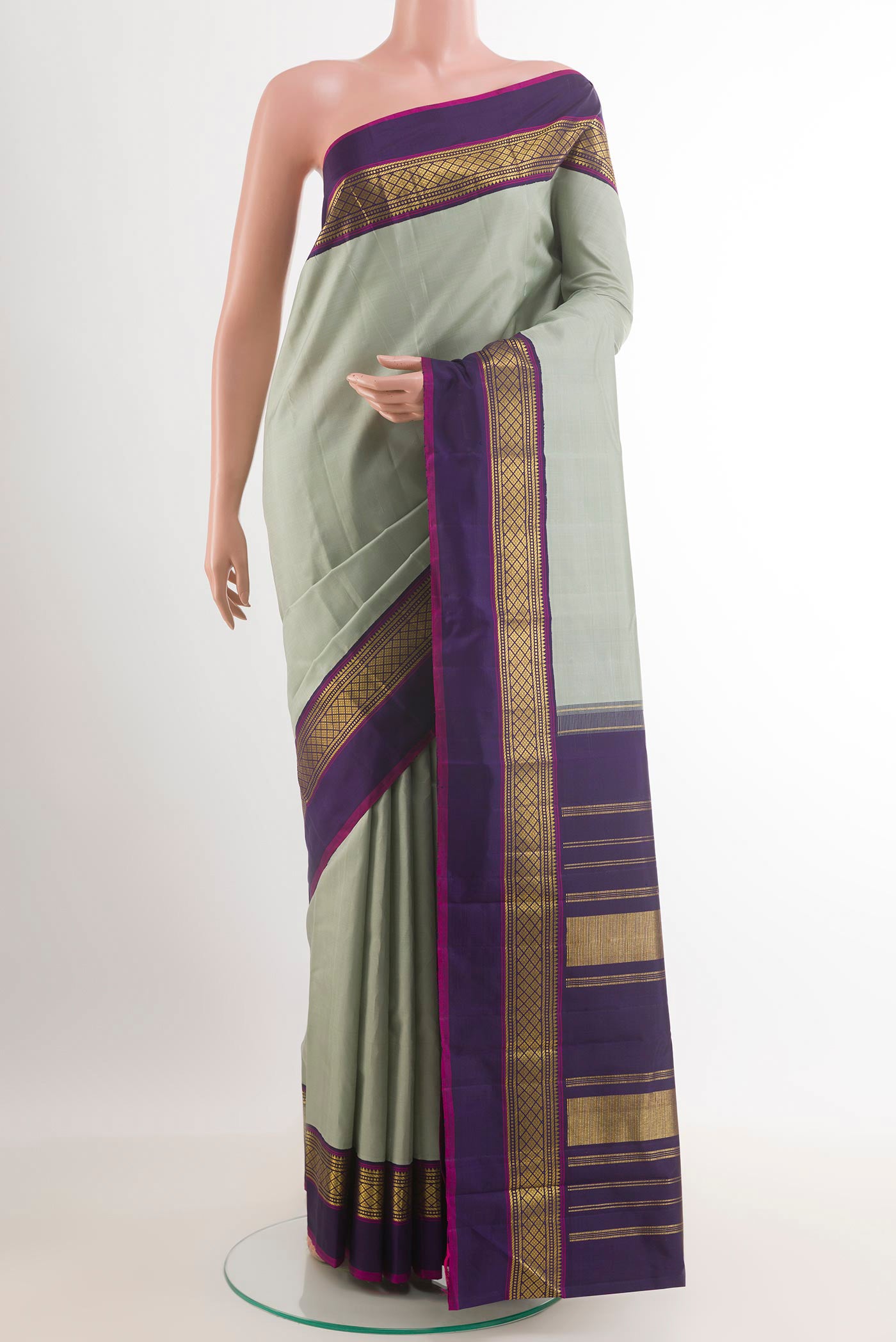 Grey Kanjivaram Silk Saree with Plain Body and Zari Border.  displayed on a mannequin