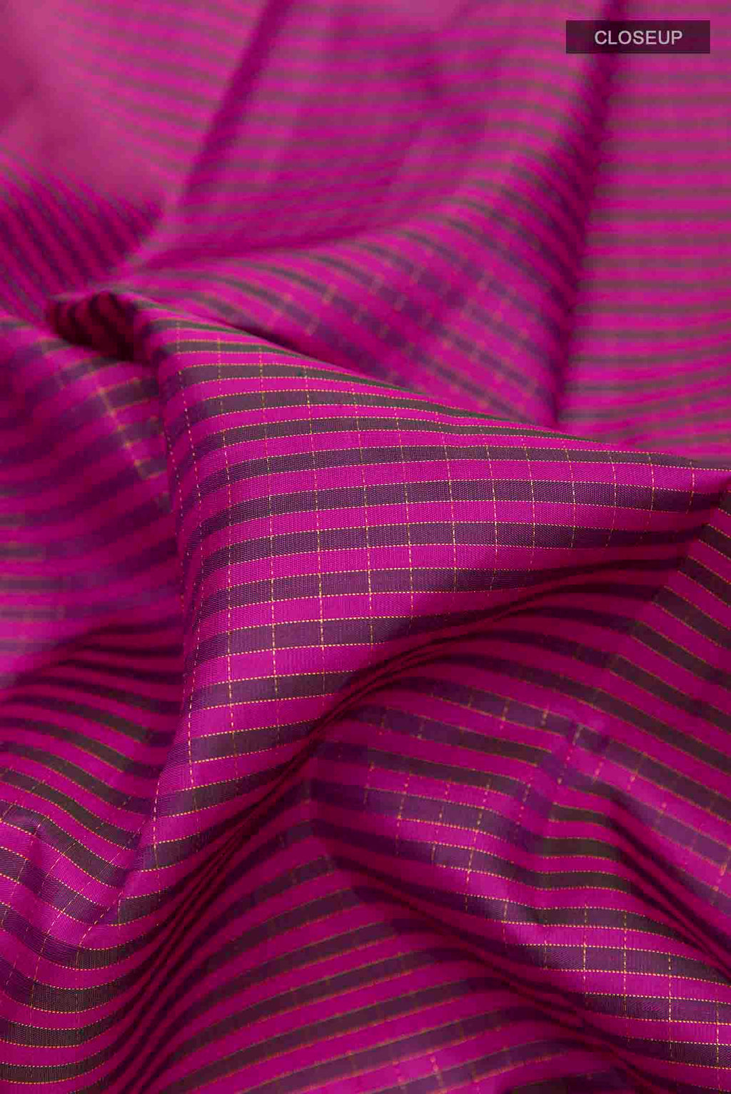 Close up of Dark Pink Kanchipuram Silk Saree with Checked design on the body and Plain Border displaying folds