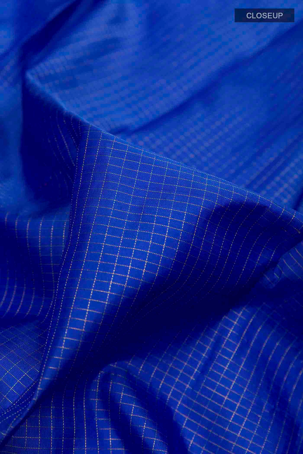 Close up of Blue Kanchipuram Silk Saree with Checked design on the body and Zari Border displaying folds