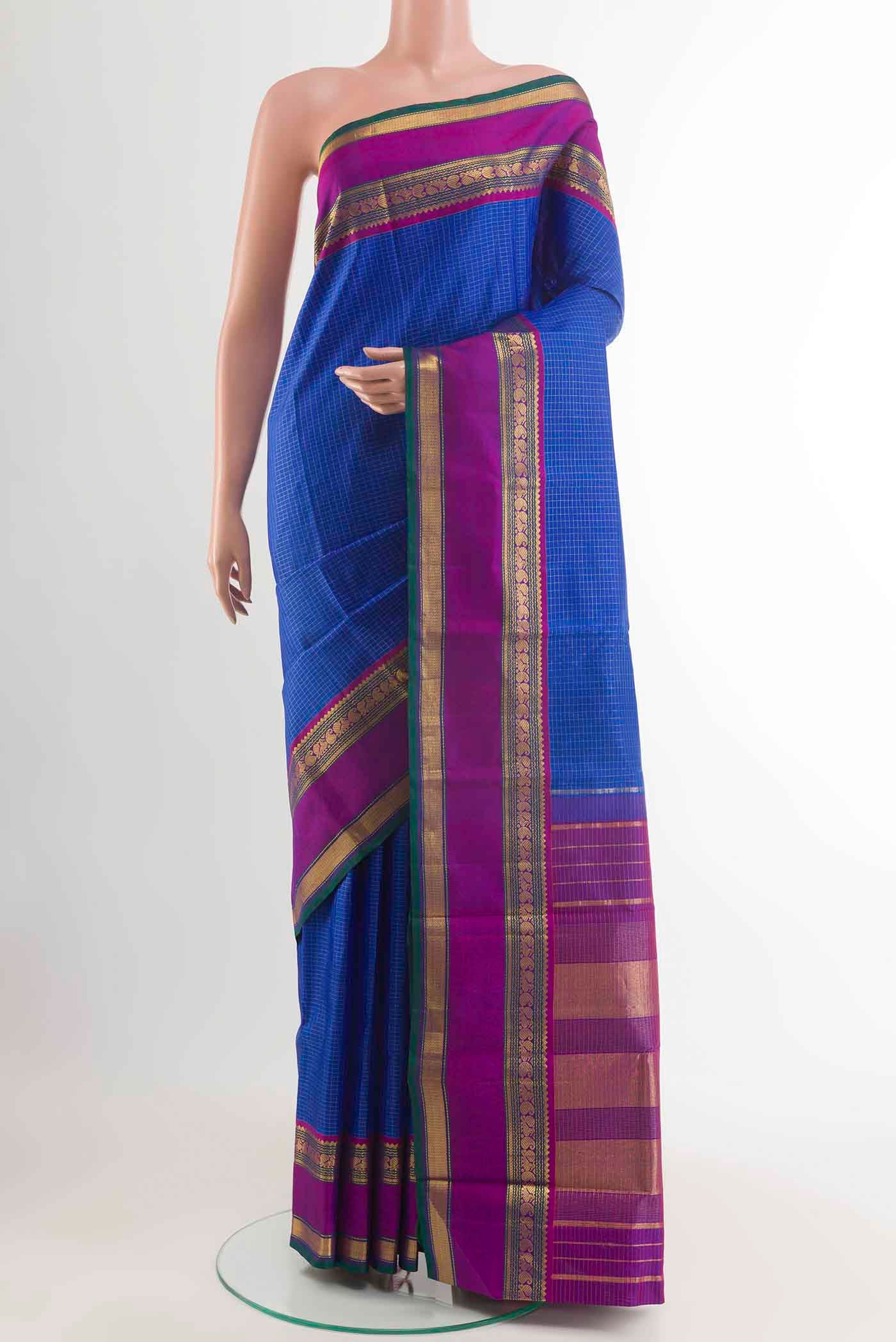 Blue Kanchipuram Silk Saree with Checked design on the body and Zari Border displayed on a mannequin