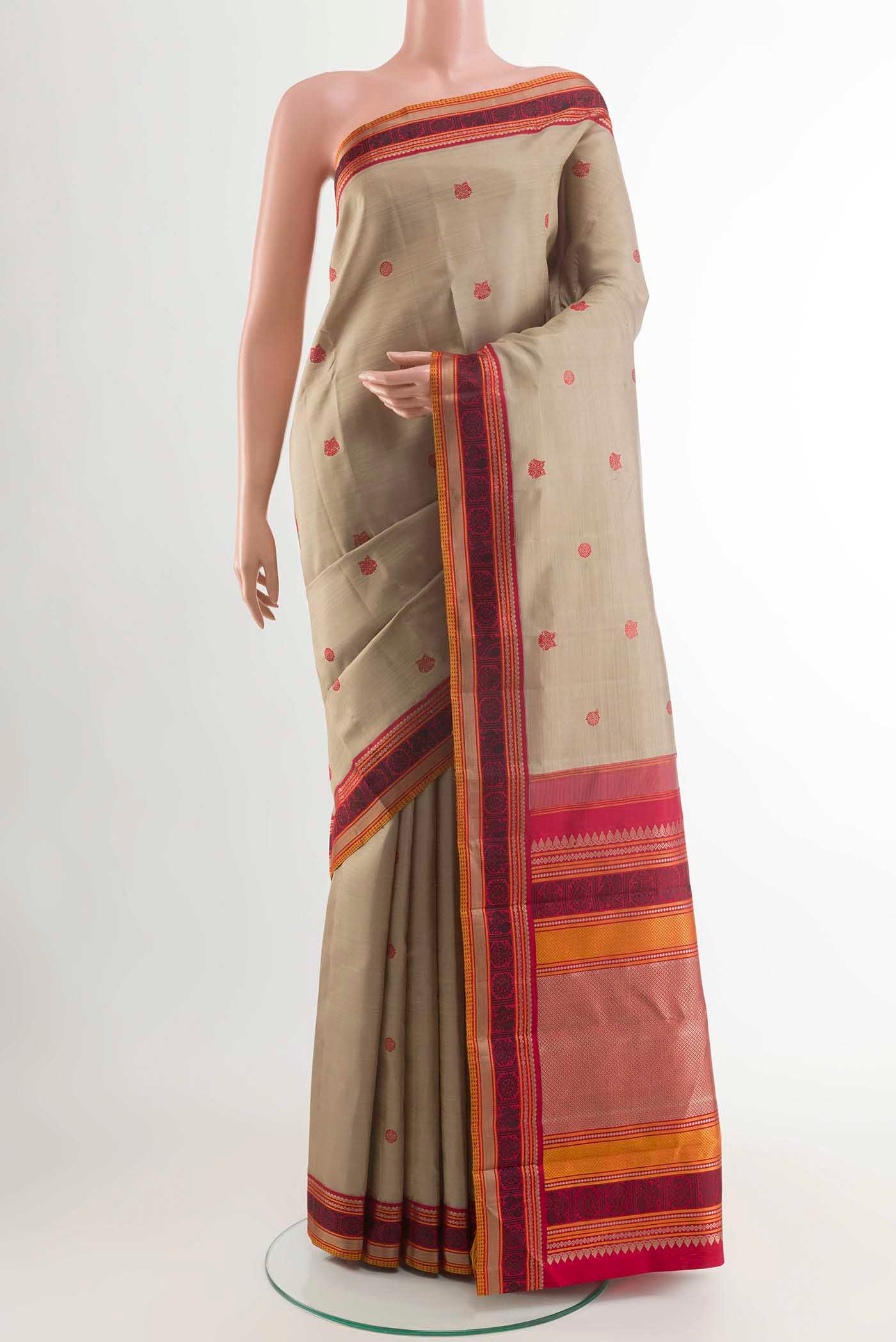 Beige Kanchipuram Silk Saree with Thread Butta on the body and Thread Border displayed on a mannequin