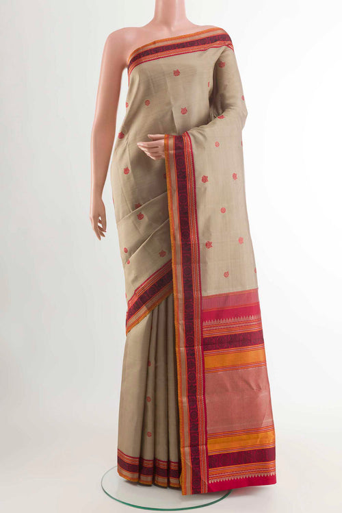 Beige Kanchipuram Silk Saree with Thread Butta on the body and Thread Border displayed on a mannequin
