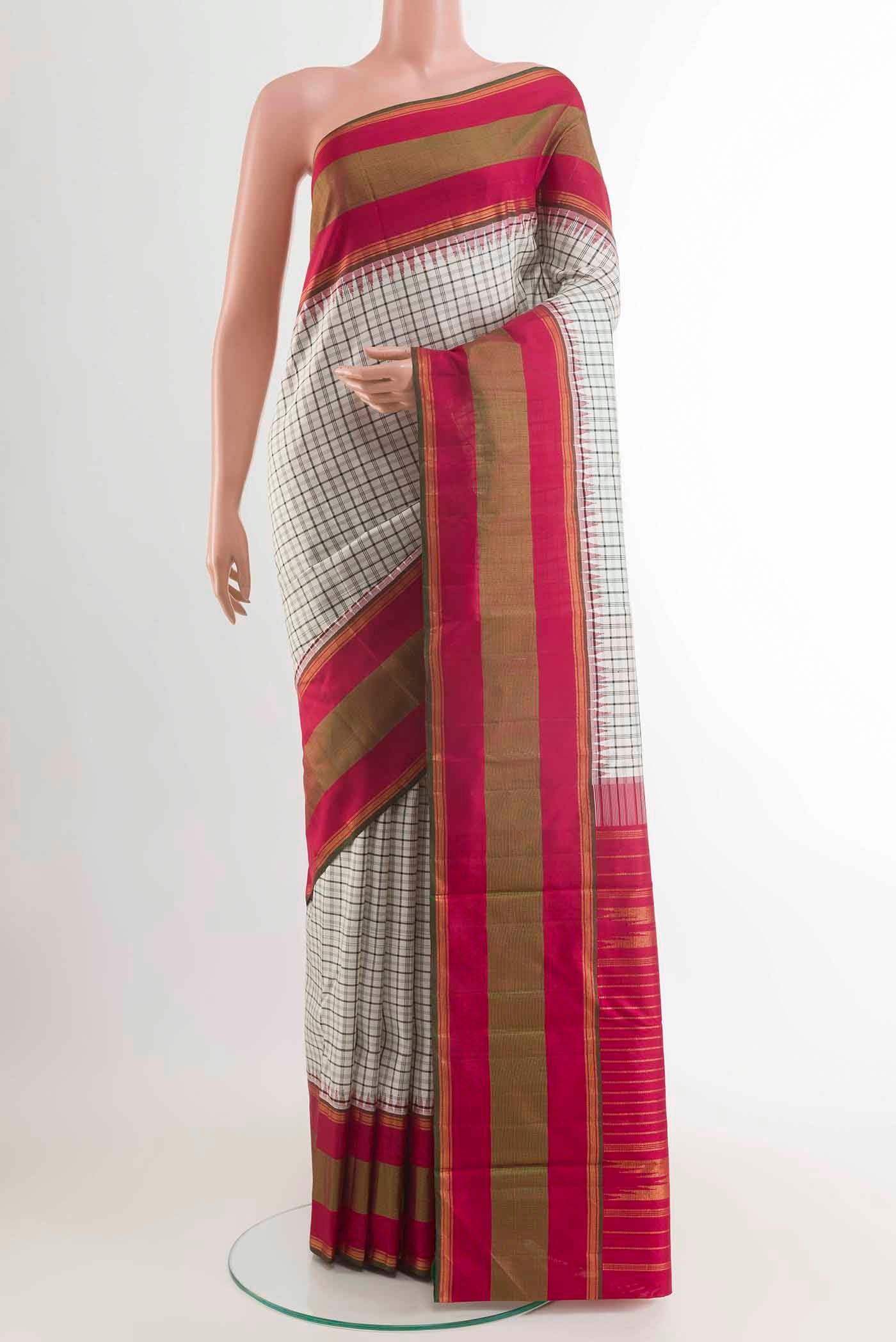 White Kanchipuram Silk Saree with Checked design on the body and Zari Border displayed on a mannequin