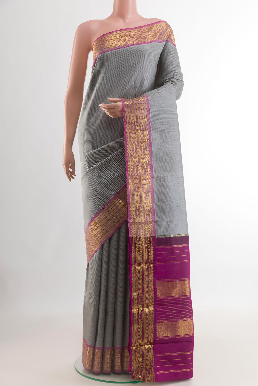 Grey Kanchipuram Silk Saree with Checked design on the body and Zari Border.  displayed on a mannequin